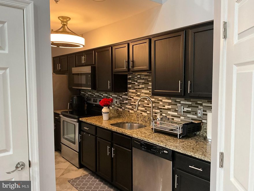 Luxury Living in the Heart of Bowie, Maryland!
Step into this beautifully upgraded 2-bedroom, 2-bath loft-style condo, where modern elegance meets everyday comfort. From the moment you enter, you’ll be captivated by the open concept design, soaring vaulted ceilings, and a cozy fireplace that anchors the inviting living space. Sliding glass doors open to your private balcony, perfect for morning coffee or evening unwinding.
The chef-inspired kitchen is a true showstopper, featuring gleaming granite countertops, premium stainless steel appliances, newly remodeled cabinets, and a layout designed for entertaining. A dedicated laundry area and utility/storage room add everyday convenience.
Retreat to two generously sized bedrooms, both showcasing rich hardwood floors and custom closet systems for maximum organization. The fully remodeled bathrooms offer spa-like finishes, including a luxurious primary bath with a soaking tub, new vanity, designer tile, and modern fixtures.
Upstairs, the versatile sunlit loft with its own private balcony offers endless possibilities — think home office, guest suite, or relaxation lounge.
Location? Unbeatable. Stroll to Bowie Town Center for shopping, dining, and entertainment. You’re also minutes to the Capitol Beltway (I-495) for easy trips to National Harbor and MGM National Harbor; quick to Route 50 East for fine dining, shopping, and waterfront fun in Annapolis; and just a straight shot on Route 50 West into downtown D.C. Thrill-seekers will love being about 7 miles from Six Flags America, and sports fans are minutes from Prince George’s Stadium, home of the Bowie Baysox.
✨ This is more than a home, it’s a lifestyle. Don’t miss your chance to own a stunning condo in one of Bowie’s most sought-after communities.
📞 Call today to schedule your private tour!