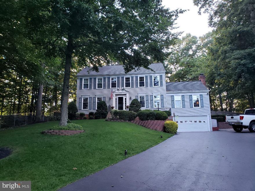 Photos Coming Soon! You do not want to miss this one!!! Welcome to 3024 Jenny Lane in Woodbridge, VA — a gorgeous 4 bedroom, 3.5 bathroom Colonial in the sought after community of Longwood Estates in the Lake Ridge area, perfectly situated on almost a full acre with exceptional indoor and outdoor living.

From the moment you enter, the home immediately impresses with a spacious formal dining room and a versatile flex room to the right, ideal for a home office, playroom, or additional sitting area. The main level also features a formal living room and an oversized coat closet, providing both functionality and staging flexibility.

The heart of the home is the expansive family room showcasing cathedral ceilings and a dramatic floor to ceiling brick fireplace, creating a warm yet striking focal point. The family room flows seamlessly into the kitchen, complete with an island, kitchenette area and stainless steel appliances including a Frigidaire refrigerator and dishwasher. Main level flooring includes hardwood and carpet. Upstairs you will find four generously sized bedrooms and the convenience of an upper level laundry room. The primary suite offers a large en suite bath with double vanity, soaking tub and separate shower, and a custom closet system designed for optimal organization.

The finished lower level expands your living space with a large recreation area, custom wet bar, full bathroom, cedar storage, and additional unfinished space perfect for storage.
Step outside to what truly sets this property apart. The backyard is a private retreat featuring a TREX deck with gazebo covered jacuzzi tub and an above ground pool fully surrounded by an expansive multi level deck. The covered hot tub area even includes a mounted TV for year round entertaining. The fully fenced yard offers abundant usable space, two storage sheds, and mature trees providing privacy and natural beauty.
Additional highlights include a 2 car garage, water heater approximately 2 years old, windows approximately 10 years old, recessed lighting, crown molding, and numerous updates to include a new pool liner and a newer hot tub.

This is a rare opportunity to own a beautifully maintained Colonial with incredible entertaining space both inside and out on almost a full acre in Woodbridge.