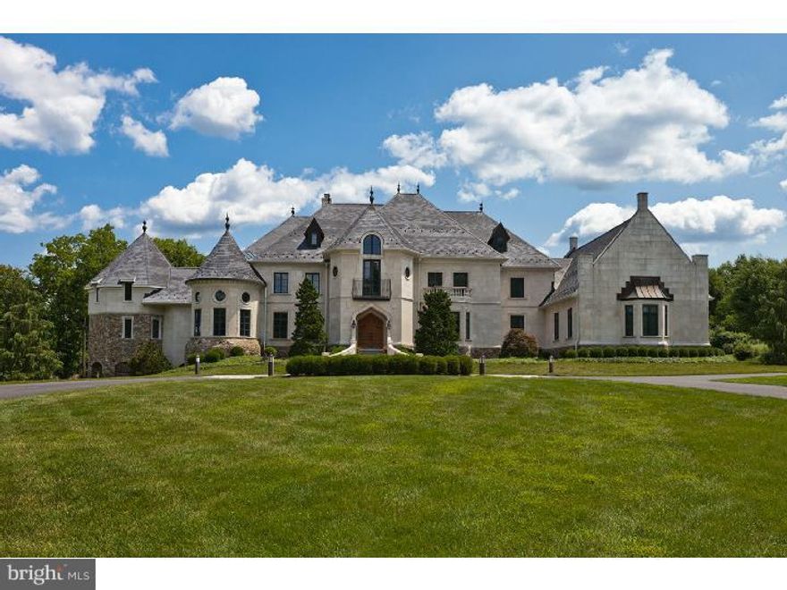 On 50 rolling acres (w/potential for subdivision) and a long serpentine driveway approach, this sprawling, custom 5 Bedroom 6.1 Bath home by Trueblood offers every living space one could ever imagine! The exterior of the home is wrapped in cast limestone, with a manufactured slate roof, stone turret and appointments, flagstone terraces, and tiered landscaping. The home is of grand scale throughout, with 10 ft. ceilings, wood and limestone flooring, extensive millwork,5 fireplaces, and more.  The formal entrance foyer w/limestone flooring showcases a grand circular staircase w/wrought iron spindles, and leads to the heart of the home, a two-story Great Room w/commanding limestone fireplace, coffered ceiling, and French doors to a flagstone terrace.  The gracious dining room has an oversized bay window, and a convenient Butler's Pantry nearby. A handsome walnut library, w/built-in cabinetry, fireplace and conference room are perfect for a home office. A two-story family/hearth  room with Mercer tile fireplace has a wet bar w/wine cooler, and leads to a Morning/Breakfast Room, the comfortable  cook's kitchen, and cozy screened porch with arch detailing.  The pro-grade kitchen with Dacor, Wolf, Asko and Subzero appliances boasts a large eating counter with granite countertops, pantry, secondary office, and access to a back staircase. The 1st floor main bedroom suite has a sitting area w/built-in bookcases, gas fireplace, large dressing area w/ walk-in closets, and full bath w/two separate vanity/water closet areas, jetted tub, and an oversized steam shower for two.  A circular staircase leads to a 2nd floor octagonal bonus room.  All spare bedrooms are en suite with full baths and walk-in closets; a spacious 46' carpeted gym w/mirrored wall completes the 2nd floor.  The full finished daylight walk-out lower level offers a billiard room, large family room w/fireplace & full bar, home theater, full bath, kitchenette, and spare bedroom w/sitting room area and full bath. The lower level accesses a covered outdoor loggia w/stone arches, hot tub, and views of the property, stone ruins & pond.  Parking for entertaining large groups of people is available on the property. Central security, central music system, zoned heat, radiant heat(1st floor & lower level) heated front steps & heated 4-car garage, back-up generator, exterior irrigation, and more!  Close to Doylestown and served by Central Bucks Schools!