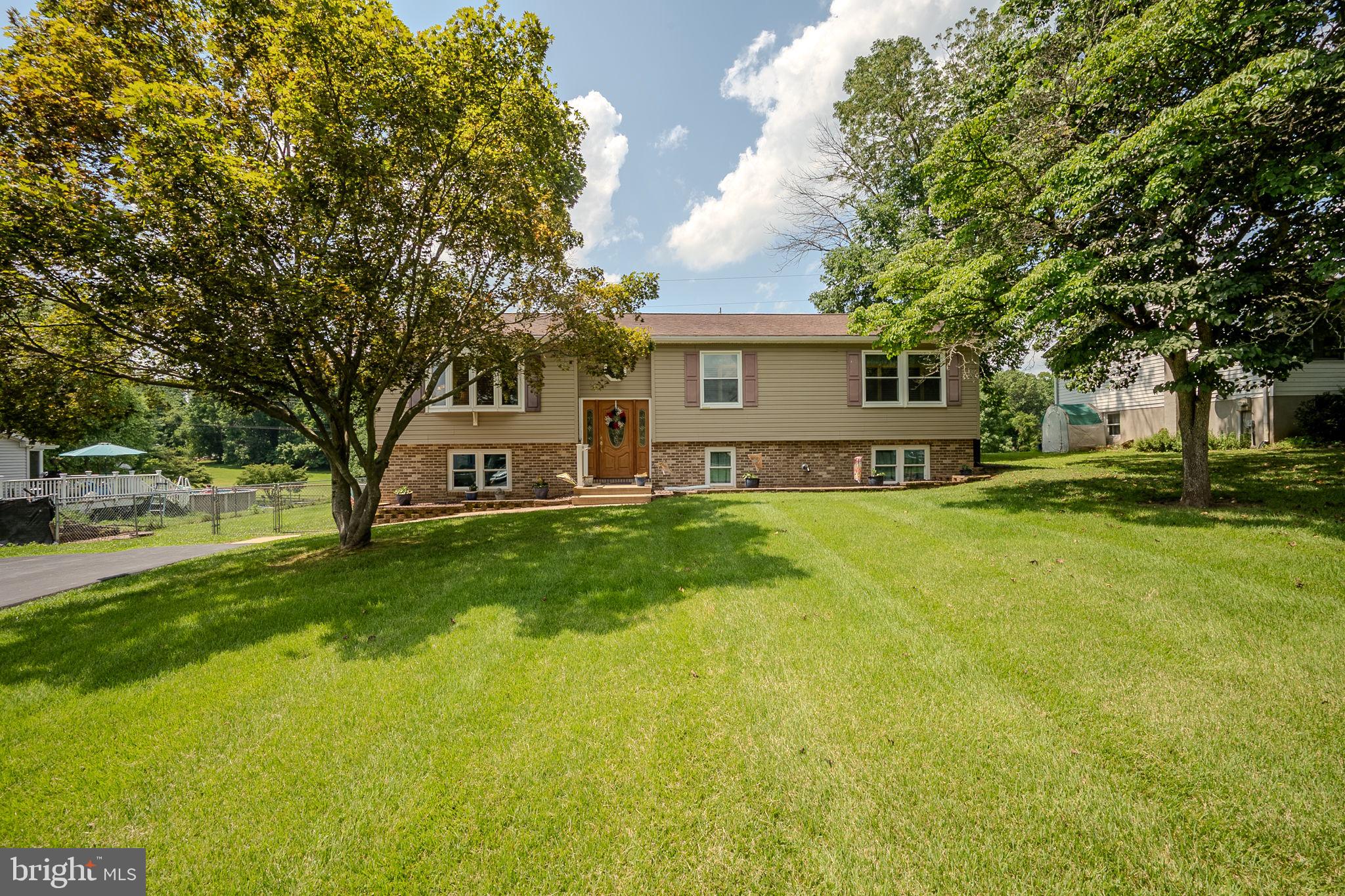 Welcome to this delightful three-bedroom home offering comfort, charm, and plenty of space to enjoy inside and out. Step inside to find a warm, inviting layout with multiple living areas perfect for relaxing or entertaining family and friends. The upper level features a living room with a bay window, three bedrooms, including a primary suite with walkout onto the extensive Trex deck, two baths and an eat-in kitchen which also enjoys direct access to the rear patio, pool area, and entertaining space. The lower level features a family room with pellet stove, ample storage options and a nicely appointed workshop with walkout to the side yard. Outside, you’ll love spending time on the large rear Trex deck , complete with under-rail lighting and SunSetter retractable awning. Relax as you overlook the expansive backyard and extensive hardscape — an ideal setting for summer barbecues, morning coffee, or gatherings under the stars. Take a refreshing dip in the pool or let pets run free in the generously sized fully-fenced yard. A lush oasis, inclusive of a firepit, and perfect for year-round enjoyment. With its versatile split-level design, spacious outdoor amenities, and plenty of room to make your own, this move-in ready home is the perfect canvas for making memories both indoors and out. Don’t miss the opportunity to enjoy peaceful living with all the space you need!