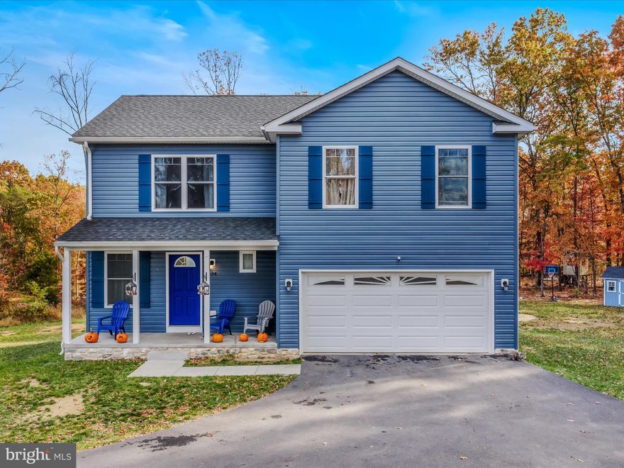 This immaculate, classic colonial features 3 finished levels of living space. With its lovely blue siding and large front porch the home exudes curb appeal. You have a large driveway for guests and an attached 2 car garage to keep your cars, and you, out of the weather. You enter the home into the spacious living room with new LVP and paint. It features a modern ceiling fan light fixture. The sliding glass door in the rear of the space provides access to your large deck. The living room is open to the dining room. This is a great set up for entertaining. The LVP carries through into the dining room and kitchen. A lovely modern farmhouse light fixture defines the dining space elegantly. Beyond the dining room is your sizeable kitchen. This space features a large pantry for ample storage. The upgraded shaker cabinets feature lovely brass handles and knobs, what a great touch. This detail is beautifully accented by the tones in the granite countertops and the clean, subway tile backsplash. All of your appliances are sleek, stainless steel. There is a nice 1/2 bath with single bowl vanity on this level as well. Upstairs you have 3 large bedrooms with tons of natural light, LVP floors, overhead lights and plenty of closet storage. The hall bath features a tub/shower and a single bowl vanity for plenty of storage. The hall also houses your 2nd floor laundry - how practical! The primary suite features LVP floors, large bright windows, and a ceiling fan light fixture. This space includes a private ensuite. Your ensuite features double bowl vanity and tub/shower combo. Your suite is topped off by a huge walk-in closet. You will want for nothing here. The lower level of the home is finished into a huge family room. With its open layout, the possible uses are endless - playroom, gym, office, theater. There is nice little 1/2 bath on this level as well. This basement does walkout to your rear yard. Outside you have a huge deck off of the living room. This is the perfect place to host Summer BBQ's or enjoy the beautiful fall leaves.  Stairs from the deck lead you down to you level rear yard. There is plenty of space to run and enjoy. Tons of mature trees give you lots of privacy. This home has everything you want, everything you need, and the space you've been looking for. Schedule your showing today!