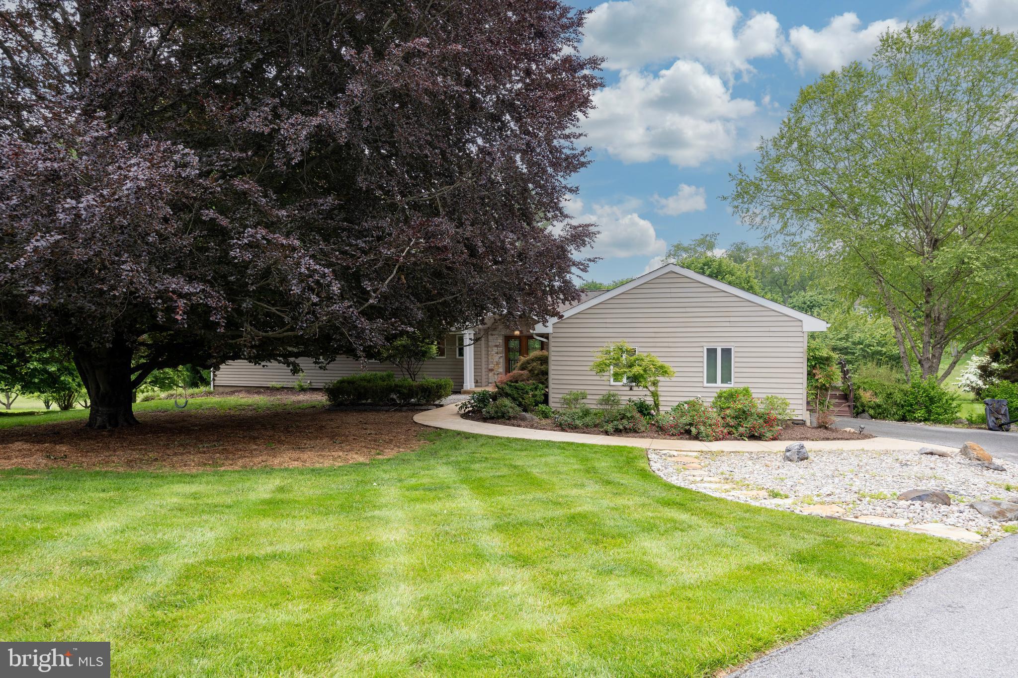 Welcome to this stunning custom-built home in the highly sought-after Radley Run community, located in the award-winning Unionville-Chadds Ford School District. This beautifully updated residence offers an open, modern floor plan with classic design elements throughout. Enter through solid mahogany double doors with beveled glass and step onto newly installed gray slate flooring. The sunken living room features expansive windows with breathtaking views of the meticulously landscaped 1.2 acre lot. The gourmet kitchen has been thoughtfully updated with top-of-the-line stainless steel appliances, including a Wolf cooktop, GE Café ovens and warming drawer, Bosch dishwasher, and Advantium combo microwave. Adjacent is a screened-in porch, perfect for entertaining or relaxing in a peaceful setting. The main-floor primary suite includes a fully renovated spa-like bath with a steam shower, jet tub, heated floors, sauna, and custom walk-in closet. Connected to the master bedroom is a flexible space that could serve as an office, gym, or even another bedroom. The possibilities are endless. An additional full bath completes the main level. The walkout lower level offers three generously sized bedrooms, a fully renovated full bath, powder room/laundry room with high-capacity washer and dryer, a media room with custom built-ins and access to a beautiful, and private, hardscaped patio. The home’s landscaping is simple and easy to maintain, yet is classic and provides a welcoming curb appeal, as well as, privacy. If you have the need, there is also an invisible, underground pet fence, so they can also enjoy the expansive property without worry. Major upgrades include a roof with 40-year shingles, new Andersen energy-efficient windows and sliding doors, engineered wood rear deck, siding with Tyvek wrap and insulation, natural stone exterior accents, and a rebuilt screened porch. Additional features include two-zone gas HVAC with HEPA filtration, a 75-gallon water heater, and a high-capacity gutter system. This meticulously maintained home is move-in ready and within walking distance to the Radley Run Country Club. Don’t miss this rare opportunity to own a turnkey home in one of Chester County’s most desirable neighborhoods!