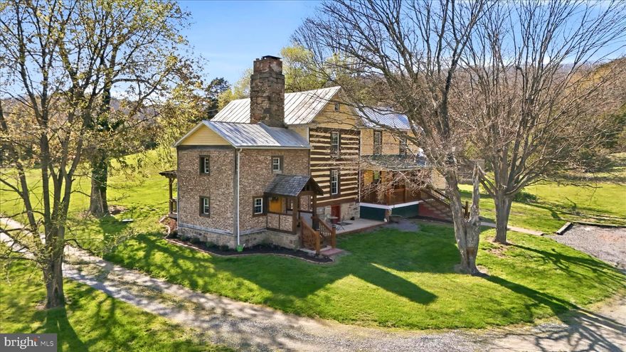 You can build a new house. You can renovate an old one. But you cannot recreate what exists here.
Originally built in the mid-1800s and restored to an exceptional standard, this one-of-a-kind log home on 10.91 unrestricted acres offers something the market rarely does: real history, real character, and real versatility in one place. With 2,820 square feet, 3 bedrooms, 2 full baths, central air, and a striking newly built barn/flex space, this is far more than a typical country property. It is a distinctive estate less than two hours from Washington, D.C. for a buyer who wants something authentic, memorable, and impossible to duplicate. The home itself is the real thing. The restoration is fresh, substantial, and thoughtfully executed, but the soul of the structure remains intact. Original logs, exposed beams, rich wood tones, stonework, fireplaces, and preserved architectural details give the home a depth and warmth that new construction cannot imitate. Every improvement was made with care, and it shows. The result is a rare blend of old-world craftsmanship and modern livability that feels both elevated and genuine. Modern comforts are already in place, including central air conditioning, high-speed 500 Mbps Frontier fiber optic internet serving both the house and the barn, and updated finishes that make the property comfortable, functional, and ready to enjoy from day one. According to Dan Oates' book The Hanging Rock Rebel, Confederate spy John Blue and Confederate Captain Ephraim Herriott discussed war plans in the log section of the house, and this is only the third family to own the property. The 10.91 unrestricted acres provide a beautiful mix of open fields and woods, creating a setting that is both usable and private. Whether your vision is a full-time residence, weekend retreat, legacy property, or simply a place to escape the pace of the city, this tract gives you room to breathe and flexibility to use it your way. The newly built heavy timber post and beam barn/flex space, built by the owner, is one of the defining features of the property. It offers 1,610 square feet of living space, along with an attached 420 square foot two-car end-to-end garage with electric. Beautifully finished and loaded with possibility, it could serve as guest quarters, private office, studio, home business location, creative workspace, entertaining venue, or Airbnb-style rental. It is rare to find a secondary improvement with this much utility, flexibility, and appeal while still fitting the character of the main residence so well. Several period outbuildings further enhance the setting and reinforce the historic character of the property. Together, the improvements create a place that feels established, layered, and truly special. This is not an ordinary log home. It is a carefully restored historic residence with real substance, beautiful land, and a newly built flex space that expands the possibilities far beyond simple country living. Opportunities like this are rare. Opportunities like this, done right, are even rarer.