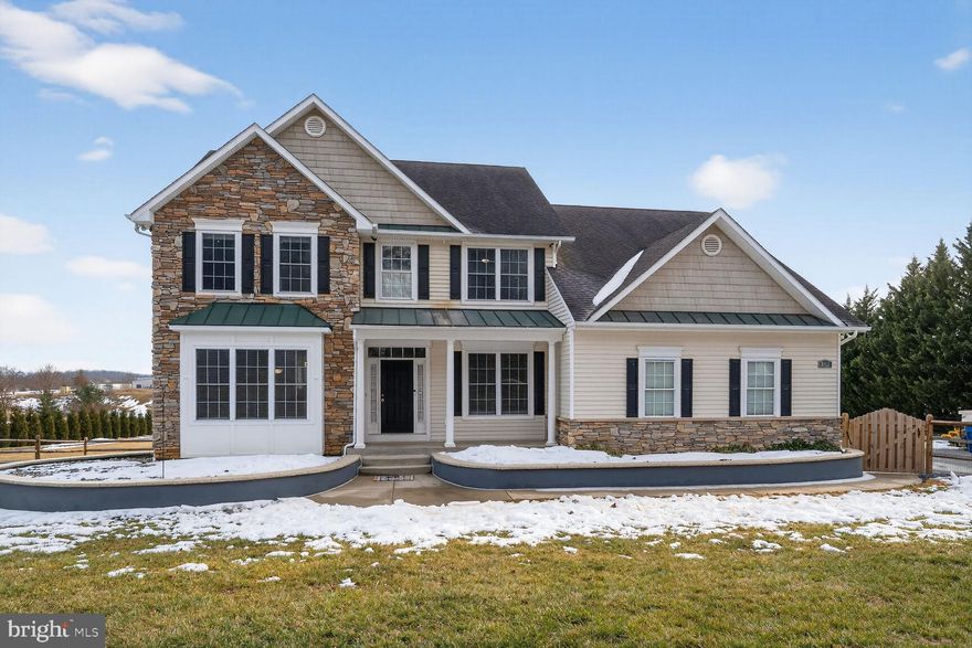 One of a kind and unforgettable, this exceptional Colonial welcomes you with breathtaking curb appeal, highlighted by raised flower beds and a charming Southern-style covered front porch that invites you to slow down and stay awhile. An additional covered porch off the family room, complete with skylights, creates the perfect setting to unwind—imagine relaxing with your favorite evening beverage while gazing at the stars, or starting your morning with a warm cup of coffee as snow gently falls around you.
Perfectly situated on a flat and usable 2-acre lot, this property is a dream for car enthusiasts and hobbyists alike. The spacious three-car garage, wide driveway, and expansive grounds offer endless possibilities, including room to add a detached outbuilding, workshop, or hobby shed.

Inside, the thoughtfully designed main level offers both elegance and functionality. A private office, living room, and dining room flow seamlessly into the heart of the home—the kitchen—featuring granite countertops, a center island, peninsula seating, and a sunlit morning room that fills the space with natural light. The kitchen opens to the inviting family room, where a cozy pellet stove creates warmth and ambiance.

The walk-out lower level expands your entertainment options with a spacious recreation room, wet bar, exercise room, half bathroom, and you could install your own private sauna—an ideal retreat for relaxation and wellness.

Upstairs, you’ll find four generously sized bedrooms, a versatile den, hall bathroom, and the luxurious primary suite. Designed to feel like your own private spa, the primary bedroom features a stunning stone gas fireplace, creating a peaceful and serene retreat. The attached primary bath offers a soaking tub, separate shower, and an extraordinary walk-in closet the size of a bedroom. The convenience of an upper-level laundry room adds ease to everyday living.

Numerous recent updates provide peace of mind, including septic pumped (2026), well pump serviced (2025), washer and dryer (2025), electric water heater (2025), garage door openers (2025), fence and powder room (2024), exterior painting (2023), microwave (2022), and a remodeled basement and refrigerator (2020).

Tucked away in the picturesque Union Bridge countryside, this remarkable home offers the perfect balance of privacy, comfort, and versatility, with endless space to host both indoor and outdoor gatherings. It is a rare opportunity to own a truly special property where every detail has been designed for living well.