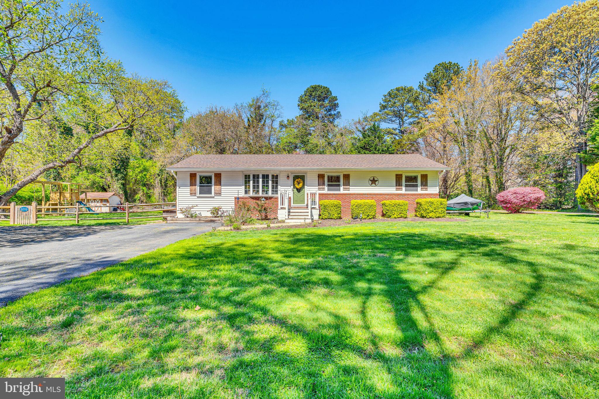 Meticulously maintained home in Hollywood in a quiet setting on a .47 acre level lot and surrounded by trees for privacy and very nice waterfront homes. It's within a mile of two marinas with boat ramps, plenty of parking places to store your boat trailers, campers, or extra toys. No HOA. The backyard is fully fenced in with a shed, workshop with power and generator hookup, and a fire pit area. The wrap-around deck is large enough for seating and grilling. The kitchen has been upgraded with granite countertops and stainless steel appliances. Custom touches have been added throughout the house, including plank boards on the wall in the kitchen, a built-in electric fireplace in the family room, a cathedral ceiling in the sitting/dining room area, and recessed lighting. This is a very special property in a beautiful setting. Don't wait. This one won't last very long on the market.