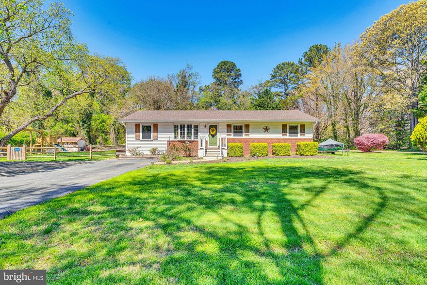 Meticulously maintained home in Hollywood in a quiet setting on a .47 acre level lot and surrounded by trees for privacy and very nice waterfront homes.  It's within a mile of two marinas with boat ramps, plenty of parking places to store your boat trailers, campers, or extra toys.  No HOA. The backyard is fully fenced in with a shed, workshop with power and generator hookup, and a fire pit area.  The wrap-around deck is large enough for seating and grilling.  The kitchen has been upgraded with granite countertops and stainless steel appliances. Custom touches have been added throughout the house, including plank boards on the wall in the kitchen, a built-in electric fireplace in the family room, a cathedral ceiling in the sitting/dining room area, and recessed lighting. This is a very special property in a beautiful setting.  Don't wait. This one won't last very long on the market.