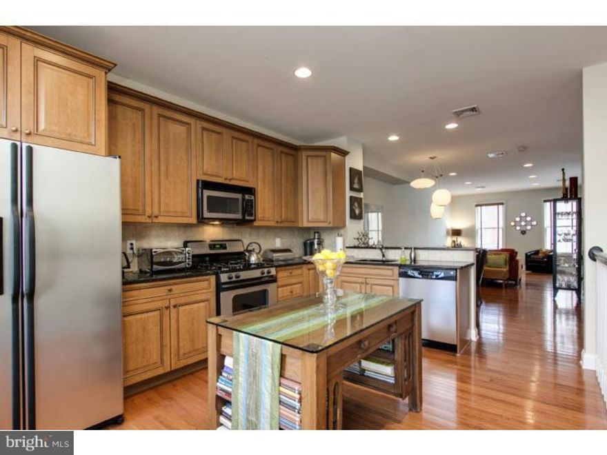 Beautiful, light filled 3 Bedroom, 3.5 Bath home with 1 CAR GARAGE in the Graduate Hospital area.  A gallery like Hall leads to a first floor Bedroom/Office with an adjacent full Bathroom and French doors that access a private outdoor patio and tranquil rock garden. Off the Bedroom, a large Basement is ready to finish with high ceilings or ideal for storage.  An over sized staircase off the main hall leads to the main living area featuring a Living room, Dining area, Powder room and Kitchen; the perfect layout for entertaining with high ceilings, hardwood floors and abundant natural light.  Gorgeous L-shaped Kitchen with bar seating, Honey stained cabinetry, granite counters and Stainless Steel appliances.  The third floors boasts TWO Bedroom suites and share a very convenient Laundry area. Each has their own full Bath, soaring vaulted ceilings, double skylights and ample closet space.  Tax abatement: 3 yrs remain. Walk to local restaurants and cafes'!  Walk Score: 92