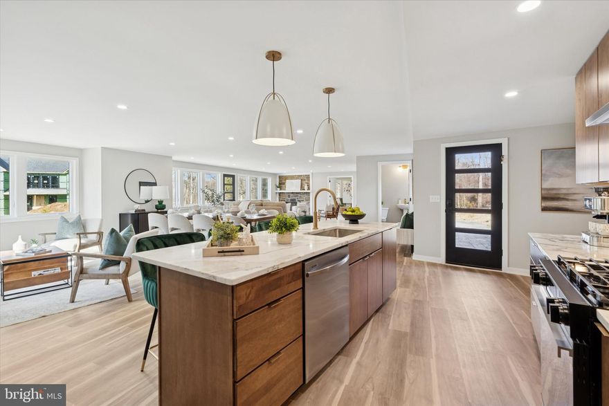 Rarely does an opportunity like this present itself. This one of a kind contemporary mid century style home has been completely remodeled from top to bottom and sits on over a half acre of beautifully manicured property. Every detail of this renovation has been thoughtfully executed, creating a spectacular move in ready home that truly checks every box. From the two car attached garage and expansive four plus car driveway, you enter into a welcoming mudroom that is perfect for a custom cubby or locker setup for shoes, backpacks, and coats. From here, the home opens into an incredible open concept layout featuring the kitchen, dining, and living areas. This space is bright, spacious, and filled with natural light, offering wraparound views of the backyard and deck through energy efficient casement windows. The kitchen is absolutely stunning with modern wood cabinetry, quartz countertops, a sprawling four seat island, gas cooking, and stainless steel appliances. The main level layout offers incredible flexibility and can easily accommodate a banquet sized dining table for holiday entertaining.  A two sided fireplace with natural gas rough in is ready to be configured to create a cozy ambiance in the sitting area. A den or study at the far end of the main level is ideal for a home office, guest bedroom, playroom, or additional living space. The second level features four generously sized bedrooms, including a beautiful primary suite with a private ensuite bathroom and a large walk in closet measuring eleven by six feet. The additional bedrooms are all bright and spacious, with two of them showcasing the unique custom geometry of this home’s architecture. The laundry room is also conveniently located on this level and features an excellent bank of cabinetry, a large stainless steel undermount sink, and a front load washer and dryer with a gas dryer. A finished basement completes the living space and offers endless possibilities for a theater room, home gym, playroom, or additional entertaining area. The basement includes a full walk up stairwell that provides easy access from the deck and backyard. The grounds of the property are equally impressive. This flat half acre lot is beautifully landscaped and manicured, allowing you to relax and enjoy the space. Some of the exterior upgrades include the front stamped concrete patio and walkway, exterior soffit lighting,  stylish black windows and trim and high end HardiePlank siding. Green Giant arborvitaes line the perimeter, creating natural privacy from neighboring homes. The brand new rear deck sits at a perfect height for seamless flow into the yard, making it ideal for entertaining, backyard games, or simply enjoying the outdoors. The quality of this renovation cannot be overstated.  The home is insulated with energy efficient closed cell spray foam and features two zone high efficiency gas forced air York furnaces with central air conditioning, a Rinnai tankless gas water heater, brand new two hundred amp electrical service, and gas and water manifold systems for easy control of future projects. Located in the highly regarded Rose Tree Media School District and set within a lovely walkable neighborhood, this home also offers easy commuter access to Route 252, the Route 1 bypass, Route 476, and I95. It is just a short ride or enjoyable walk into Media Borough where you can enjoy outstanding dining, nightlife, and shopping. Schedule your tour today to experience this exceptional home in person.