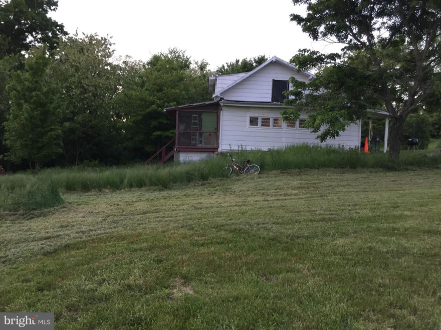 This property is 6.78 lovely acres with a house. Has well and septic on the property. Property fronts on Winchester Grade Road with easy access to the property. Mountain views in all directions. just 11 miles from Berkeley Springs, Easy access to Winchester VA or Martinsburg, WV. Great location to build a new home or renovate existing to your get-a-way spot. Property Sold As Is.  As exist.