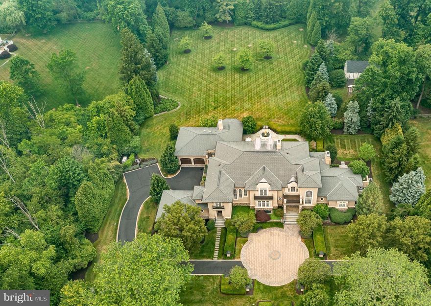 Spectacular presentation & value beyond belief! All you could ever dream for lifestyle, amenities & quality! Opulent, exquisite, architecturally sophisticated, this incredible residence offers an exceptional lifestyle with panache & comfort in equal measures! Situated on 2 +/-Ac & combines every conceivable luxury & lavish amenity & offers enviable privacy & timeless elegance. Grandeur & unparalleled sunlit warmth & welcome is the dramatic entry Foyer of this palatial residence. Opulent & harmonious blend of formal & informal Living Areas with spacious & open floor plan is an ideal flow for hosting formal or casual entertaining, special occasions or gatherings. Custom Design Gourmet Kitchen is every Chef's delight with its ease in entertaining & effortlessness for everyday use. In-home Office/Den is presidential with custom woodwork & built-in desk & cabinetry. Sumptuous 1st Floor Master Suite - Splendid hideaway & ultimate in luxuriousness! Multiple custom sweeping staircases with 2nd Floor balcony overlooks that are graced in elegant balustrades & custom handrails. 2nd Floor Bedroom Suites each with private luxurious Bath. Tucked Away yet Easily Accessible is a "Sanctuary" of recreation & casual entertainment-This is what it feels like to live the dream celebrity lifestyle & it's time to enjoy! Golf simulator, chaired wet bar, Fitness Room, Home Theater, Wine Cellar & Sitting Area. Sun-dappled outdoor living oasis is a slice of paradise! Secluded Eden parklike lush gardens & setting enchant you with majestic rear yard vistas. Sweeping lane drive, hidden motor court with 4 separate & oversized Garage spaces with auto openers & plenty of off-street parking. Advanced "Smart Home" automation that makes whole house operation as simple as a push of a button, touch of a screen or click on the computer monitor. Phone & intercom communications, sound & security systems with central monitoring. Gwynedd Valley is saturated in historic sites & preserved open space & offers parks, walking trails, shopping & fine dining. Downtown Ambler & the quaint Village of Skippack also offer an afternoon or evening get-a-way! Easy access to NY, Wash, Phila & Jersey shore. Gwynedd Valley Train Station-Phila is short 20-minute ride! Easy access to major Highways & Interstates, Wings Field & Phila International Airport. Lives & feels way bigger than 9,200 sq. ft. Built to impress & luxury living exceeding your wildest dreams!