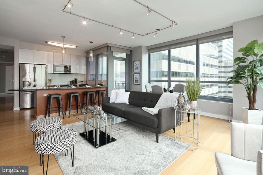 A spacious and luxurious condominium with amazing South and East facing views. This 2-bedroom, 3-bath + DEN residence features modern and luxurious finishes. Granite counter tops, wood floors, stainless steel appliances, 9-foot ceilings with floor to ceiling windows. The price includes 1 reserved parking space in the attached covered garage, and a storage locker. The building features a 24HR Concierge, fitness center, a heated 60FT lap pool, renovated sundeck/community room and much, much more! The building is situated conveniently next door to Trader Joes and Wine & Spirits - and is just walking distance from Philadelphia's top-rated restaurants. Spend the day shopping in Rittenhouse, or enjoying the sights at Boathouse Row, you can't beat the location and attractions located right near the Murano!