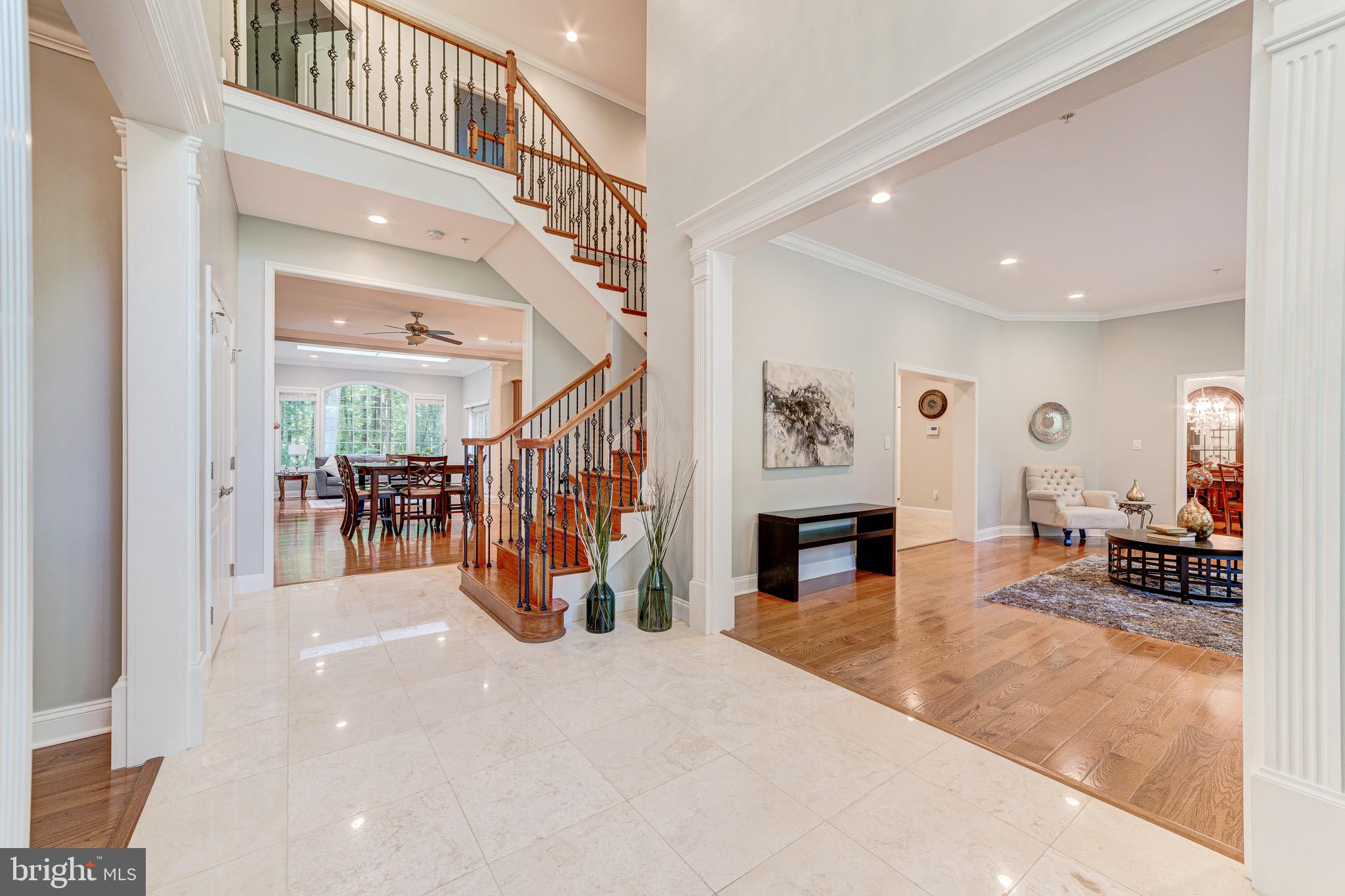 Priced to sell! Luxury living awaits you in over 4800 square feet plus 1794 square feet basement in the heart of Potomac! Completely reconstructed in 2014! This 4BR / 5.5 BA home with a 3 car garage is truly an entertainer s dream, inside and out. Walk through a stunning 2 story foyer with Travertine tiles into a spacious open kitchen with 6 burner high-end Therm-adore gas stove and beautiful granite counter tops with with Vac-Pan, family and morning room with breathtaking views. Upstairs has a grand master bedroom with sitting room, TWO walk-in closets & craft closet, with a glorious master bathroom. Enjoy a beautiful outdoor yard with a stone patio on nearly an acre lot. Work at home in a separate office or use it as a den. Main level bedroom with full bath. Laundry room on upper level. House has Central Vac throughout & vac pan in kitchen. Finished lower level with wet bar adds more space to enjoy with media room, rec area, full bath, and additional storage areas. Main and upstairs hardwood floors. In the heart of the desirable Churchill school district, minutes from Montgomery Mall, I-270, and Potomac Village. NO HOA FEES. visit:10105BevernLane.C21.com . To view Unique Property Site, please visit:10105BevernLane.C21.com