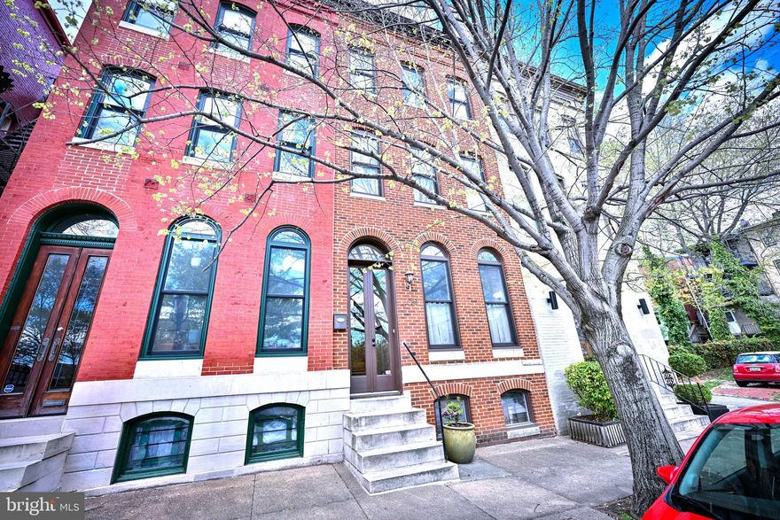 Welcome to 240 Wilson Street in historic Bolton Hill—a simply stunning home that blends classic charm with modern style.

This beautifully renovated home has 4 bedrooms and 3.5 bathrooms spread across four finished levels, giving you plenty of space to live, work, and relax. Sunlight fills every room through large windows and multiple skylights, highlighting the gorgeous hardwood floors and high ceilings throughout the home.

As you enter the home from the large glass front double doors, you are welcomed main foyer that leads to a spacious living room with alcove. Seamlessly flowing into the dining area, this level has 2 decorative fireplaces (gas lines disconnected).

The gourmet kitchen is a true standout, featuring granite countertops, a decorative tile backsplash, stainless steel appliances, a commercial-grade range, and custom cabinets—perfect for cooking and entertaining. Off the kitchen, you’ll find a fenced rear brick patio, ideal for relaxing or hosting guests.  

On the second level of the home you will find 3 ample sized bedrooms and two full bathrooms, including one of two primary suites in the home. Each bathroom has been tastefully updated with stylish finishes. 
One of the dual zone units is located on this level as well.

The top floor of the home comprises the private primary suite retreat. It includes a spacious bedroom, a luxury bathroom with glass tile, and your own private balcony—perfect for enjoying your morning coffee or unwinding at the end of the day.

The lower level offers a bright and flexible space that can be used as a rec room, home office, or both. Moreover, the unfinished portion can be used for a workroom or is perfect for additional storage. The second zone heating and cooling system, water heater and laundry are located here.  NOTE: The AC portions of the dual zone systems were replaced in both units in 2019.

This home truly has it all—space, style, and a prime location in one of Baltimore’s historic neighborhoods (on both local and national historic registries).  And as such, homeowners are bound by rules to preserve the neighborhood’s historic character. Any exterior changes to homes in Bolton Hill must be in keeping with historic preservation standards, as approved by Baltimore City’s CHAP division.

Bolton Hill is also part of the Part of the Mid-Town Benefits District, a neighborhood advocacy and improvement group , which provides cleaning, greening, and safety services as well as community advocacy and activities. These extra services are paid via an additional fee by all residents within these Districts.