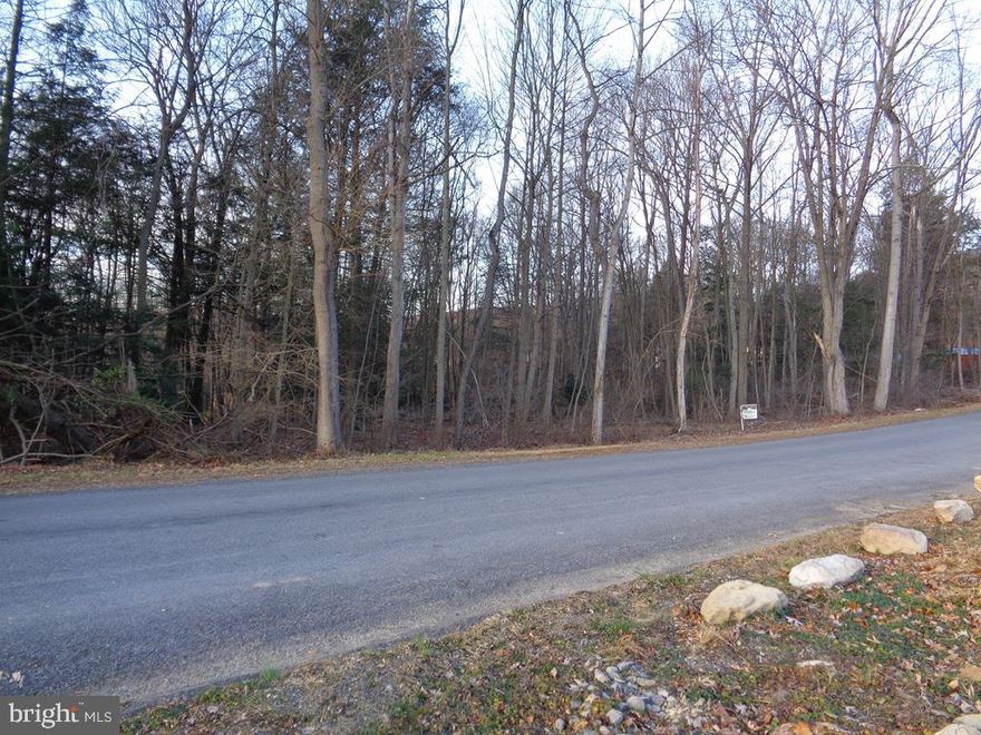 Wooded acres for your new home.  Very quiet rural neighborhood few miles to 322.  Septic design, septic permit, septic layout, driveway permit, addressing fee all included in price.  Parcel D on survey.  Well needed.