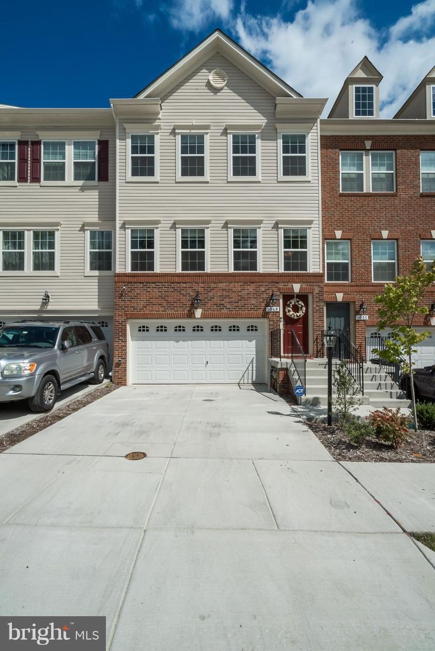 This 4 level townhouse is 4 months young and ready to move in. Wood floors on main level,  kitchen with SS appliances, granite counters, large Island, pantry & door to a large deck. 3 BR, 2 BA on upper level; loft and bath on 4th level opening to roof top deck. Walk out Lower level has rec room, bath and mud room. Custom Levelor blinds on all windows and doors, ADT Sec. system & home automation.