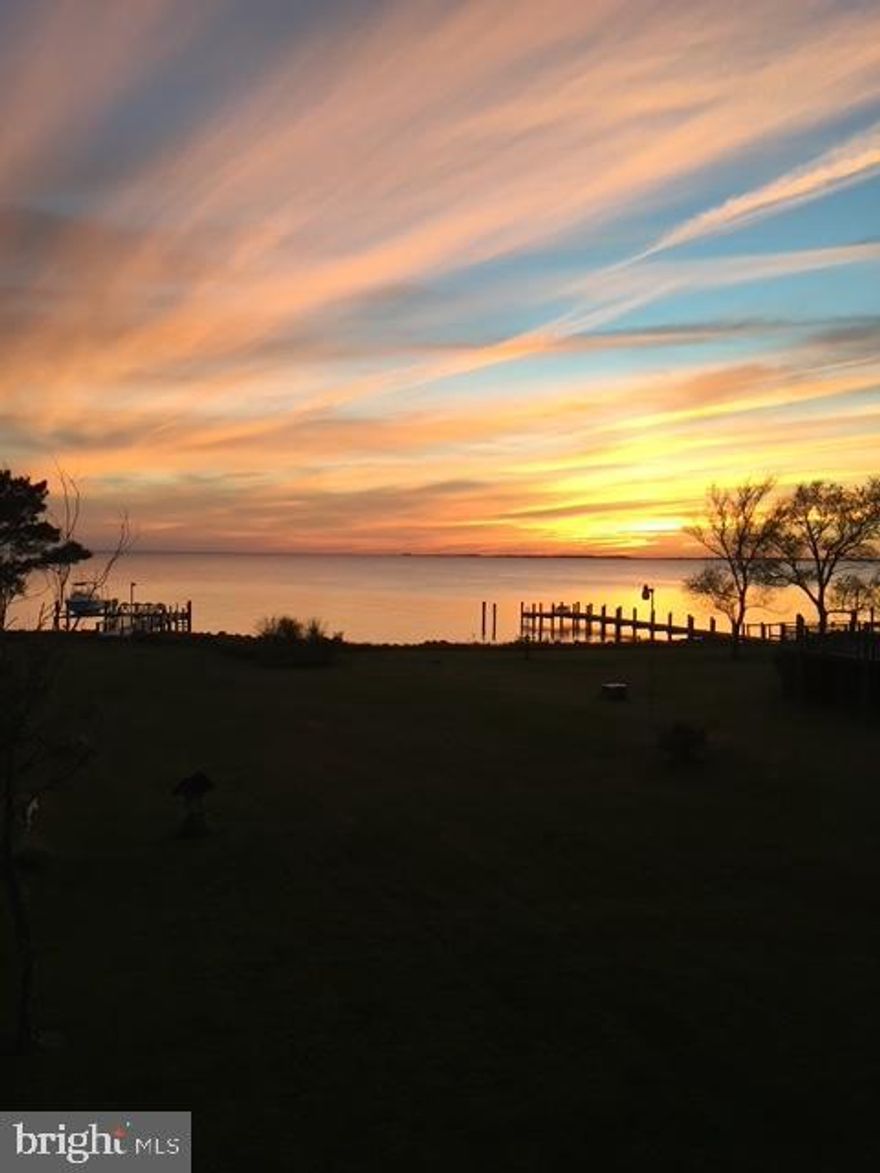 Designed by the award-winning Becker Morgan Group, this custom waterfront home features one of the best locations on the eastern shore to view the most breathtaking sunsets.  Located on 4.3 acres, the property has 1908 sq ft of living space. A second story great room with cathedral ceilings is roomy and comfortable and includes a stone, wood -burning fireplace, fabulous windows overlooking the river, master bedroom ,bath and balcony with walk in closet .
There is also another bedroom upstairs and half bath in the hallway. On the first floor, as you enter, you will see a bright and cheery kitchen/dining space with a screened -in porch off the dining area. Perfect for your summer days of swimming, boating and then eating crabs on the porch! Counters are granite with stainless steel sink and many cream cabinets. A cool tile floor  provides easy clean up. Lots of space for  bar chairs to fit under the kit counter ledge if you prefer that .  A first floor guest room and full bath are also on this floor.
There is 126 ft of rip-rap bulkheading , a pier and boat lift for your enjoyment. You are allowed to crab from your own pier or fish. Directly across you can see Elliotts Island and from there the Chesapeake Bay. Immerse yourself in the outdoors, the quiet peaceful feelings, and nature!! What are you waiting for?