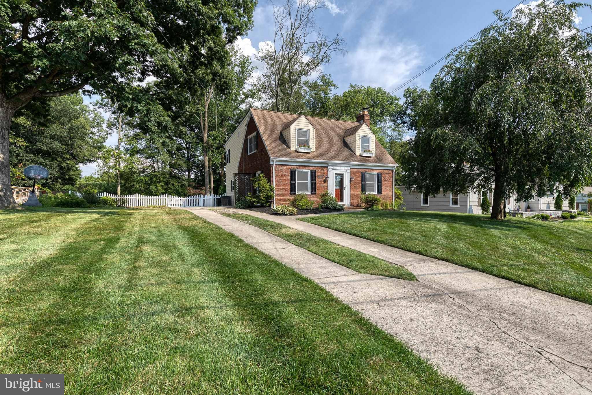 Welcome home to this beautifully maintained traditional brick front home, nestled on a picturesque and level half-acre lot in the sought-after Graham Place neighborhood of Catonsville. Surrounded by mature trees and a classic white picket fence, this property offers the perfect blend of timeless charm and modern convenience.
Step inside to find a spacious and inviting layout featuring four bedrooms and one and a half bathrooms. The main level boasts a rare first-floor primary bedroom—perfect for convenient main-level living if desired. The cozy living room is centered around a warm wood-burning fireplace, creating the perfect spot to unwind.
The heart of the home is the expansive eat-in kitchen, complete with granite countertops, custom maple wood cabinetry, and direct access to the backyard patio—ideal for summer BBQs, al fresco dining, or simply enjoying the glow of fireflies on warm evenings.
Upstairs, you'll find three oversized bedrooms and a stunning sunroom filled with natural light. This versatile space offers endless possibilities and could easily be converted into a luxurious second-floor primary bath. Key updates include: LVP flooring in sunroom and basement (2025), fresh paint throughout (2025), full main plumbing replacement (2024), EV charger & 50-amp exterior plug (2023), all new windows throughout (2022), refrigerator (2021), hot water heater (2017). There is a new playset for the backyard for hours of fun in the great fall weather! Please note that the original square footage is wrong; the addition added an extra above grade footprint.
This home is everything you love about Catonsville… walking distance to Westchester Elementary and Catonsville Middle Schools, Opies and Tasty Zone, the legendary Catonsville Fourth of July Parade, and the Trolley Trail #9, as well as a short drive to both downtown Catonsville and Historic Old Ellicott City! With plenty of room to grow, entertain, and relax—inside and out—this home offers a rare opportunity to enjoy classic Catonsville living with thoughtful modern upgrades. Come see why life is great in 21228, book your private showing today because this one isn’t going to last long!!!