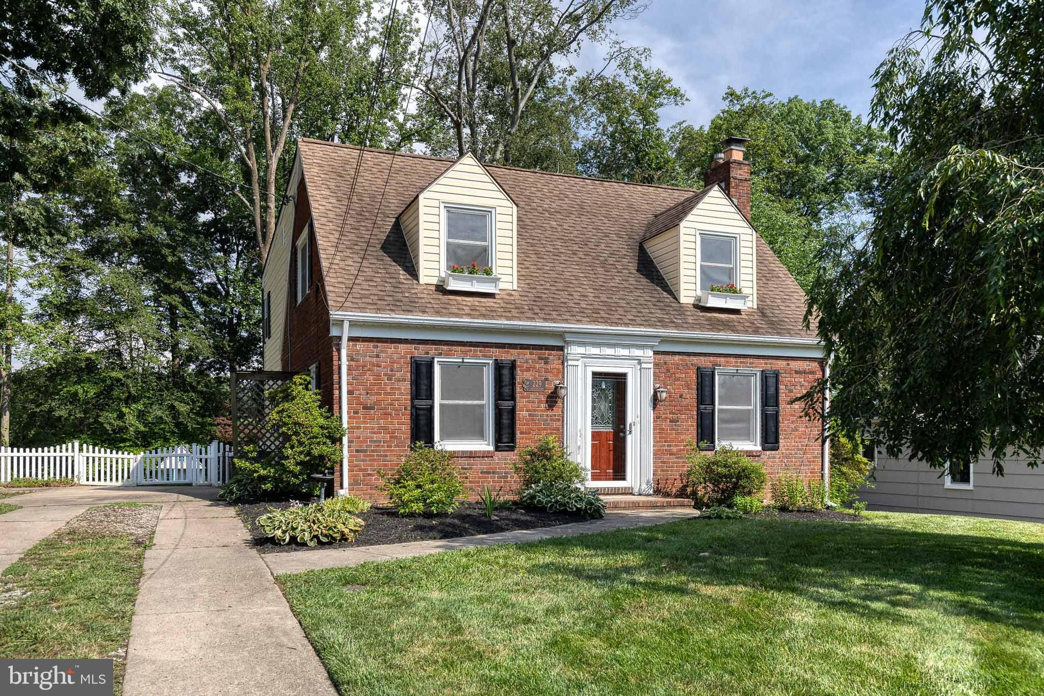 Professional photos to be uploaded this week! Welcome home to this beautifully maintained traditional brick front home, nestled on a picturesque and level half-acre lot in the sought-after Graham Place neighborhood of Catonsville. Surrounded by mature trees and a classic white picket fence, this property offers the perfect blend of timeless charm and modern convenience.
Step inside to find a spacious and inviting layout featuring four bedrooms and one and a half bathrooms. The main level boasts a rare first-floor primary bedroom—perfect for convenient main-level living if desired. The cozy living room is centered around a warm wood-burning fireplace, creating the perfect spot to unwind.
The heart of the home is the expansive eat-in kitchen, complete with granite countertops, custom maple wood cabinetry, and direct access to the backyard patio—ideal for summer BBQs, al fresco dining, or simply enjoying the glow of fireflies on warm evenings.
Upstairs, you'll find three oversized bedrooms and a stunning sunroom filled with natural light. This versatile space offers endless possibilities and could easily be converted into a luxurious second-floor primary bath. Key updates include: LVP flooring in sunroom and basement (2025), fresh paint throughout (2025), full main plumbing replacement (2024), EV charger & 50-amp exterior plug (2023), all new windows throughout (2022), refrigerator (2021), hot water heater (2017). There is a new playset for the backyard but it has not been installed yet. Please note that the original square footage is wrong; the addition added an extra above grade footprint.
This home is everything you love about Catonsville… walking distance to Westchester Elementary and Catonsville Middle Schools, Opies and Tasty Zone, the legendary Catonsville Fourth of July Parade, and the Trolley Trail #9, as well as a short drive to both downtown Catonsville and Historic Old Ellicott City! With plenty of room to grow, entertain, and relax—inside and out—this home offers a rare opportunity to enjoy classic Catonsville living with thoughtful modern upgrades. Come see why life is great in 21228, book your private showing today because this one isn’t going to last long!!!