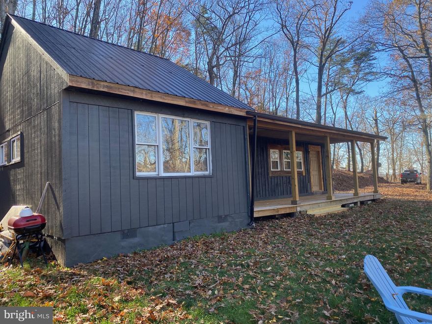 This charming 2-bedroom, 1-bath cabin, beautifully remodeled and nestled on 10.89 acres across two lots, is situated at the end of Bunker Lane in Lake Ferndale, Springfield, WV. The cabin features durable laminate flooring and ceramic tiles in the bathroom, a spacious primary bedroom with vaulted ceilings, and a convenient laundry room. The kitchen, equipped with brand-new appliances that convey with the property, opens up to a generous living room. Enjoy the serene and private setting from the inviting covered porch.

Lake Ferndale is a tranquil residential and vacation community surrounded by cool, mountain woods and centered around a private 50-acre lake. Located about 2.5 hours from Washington, DC, and Pittsburgh, PA, and just an hour from Berkeley Springs, WV, and Winchester, VA, it offers a peaceful retreat with ample recreational opportunities.

Residents can bask in the sun and swim at the private community beach, host picnics and celebrations at the new lakeside pavilion, or fish and paddle around the lake. Additionally, you’ll have access to the nearby South Branch of the Potomac River for further outdoor enjoyment.