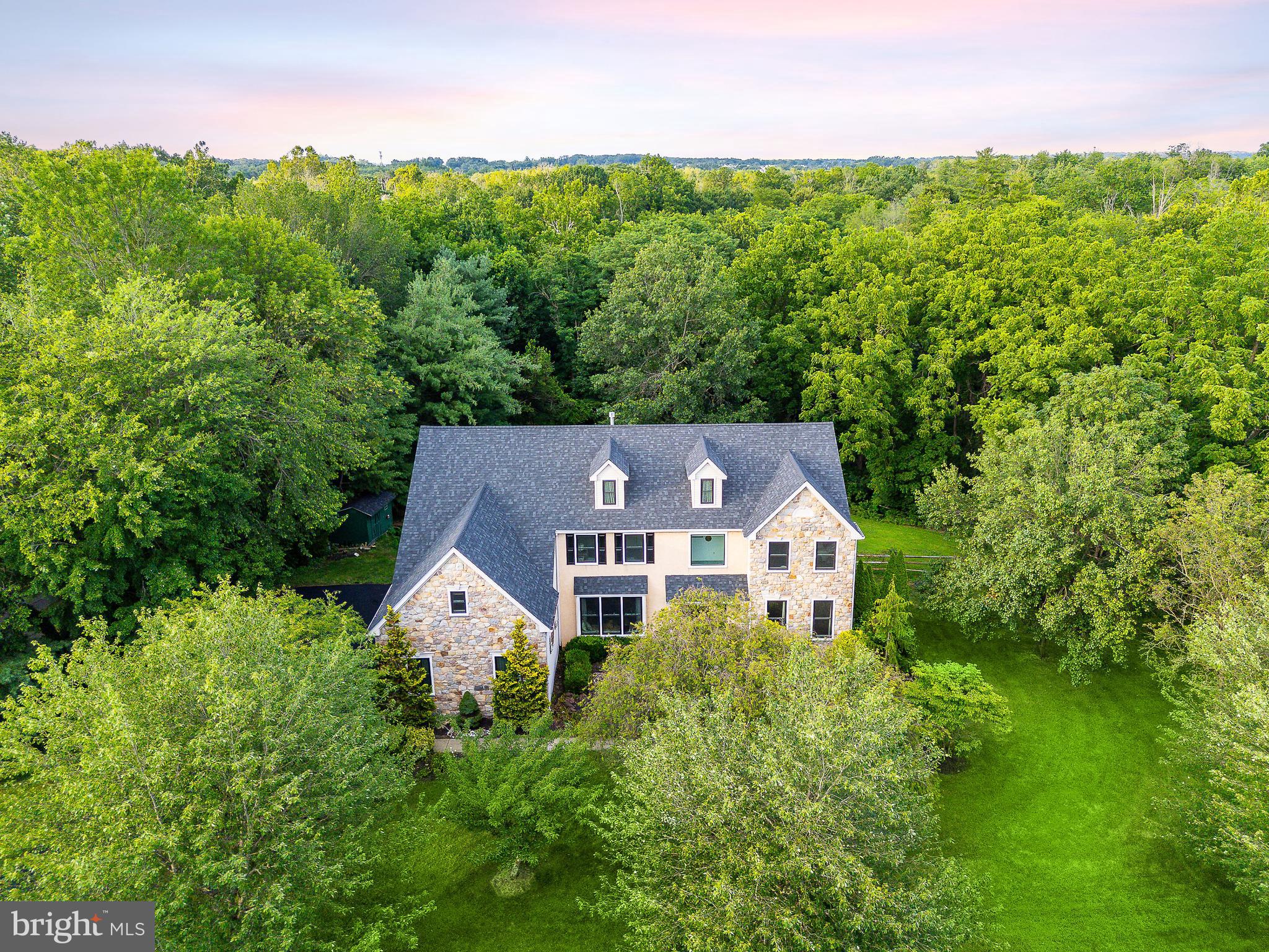 Tucked away on a premium lot backing to protected woods and the tranquil Little Neshaminy Creek, this stunning Guidi-built home is a rare blend of elegance, space, and serenity. Lots with this type of privacy do not come around often and with over 6,500 square feet of total space, this 5-bedroom, 3.5-bath gem is loaded with thoughtful upgrades—new roof (2022), energy-efficient BLACK windows and skylights (2023), and new HVAC and hot water system (2020). Inside, the soaring two-story foyer leads to a grand living and dining room, while the light-filled family room stuns with a floor-to-ceiling stone fireplace and skylights above. The open-concept kitchen is perfect for everyday living and entertaining, complete with a granite island, tiled backsplash, and direct access to an oversized engineered wood deck that’s ideal for summer barbecues or fall mornings with coffee. A private first-floor office and tucked-away laundry room offer function and flexibility. The finished walkout basement features a guest bedroom and a custom oak bar—ready for game nights or in-law stays. On the 2nd floor you'll find a large primary suite with sitting room outside the primary bedroom which includes a his & her closet and ensuite black marble bathroom. 4 more bedrooms are included on this floor with a jack and jill full bath and additional full bath off the hallway. IF this wasn't enough space for you the attic has the ability to be finished by adding a staircase giving you a large 3rd floor suite that has 2 dormers already in place. Finally, with 3-car garage parking, space for 6 more in the newly resealed driveway (2025), and a large shed for extra storage, every detail here has been dialed in.
Located in award-winning North Penn School District, you’re just minutes from it all. Hop on Route 309 or the PA Turnpike for an easy commute, or catch the train from the nearby North Wales or Gwynedd Valley stations. Explore scenic walking trails at Parkside Place, take the dog to Windlestrae Park, grab dinner at Iron Hill Brewery or The Pour House, and hit your workouts at LA Fitness or Orangetheory Fitness—all within a 10-minute drive. Privacy, luxury, and lifestyle—this home has it all. Come see it before it’s gone.