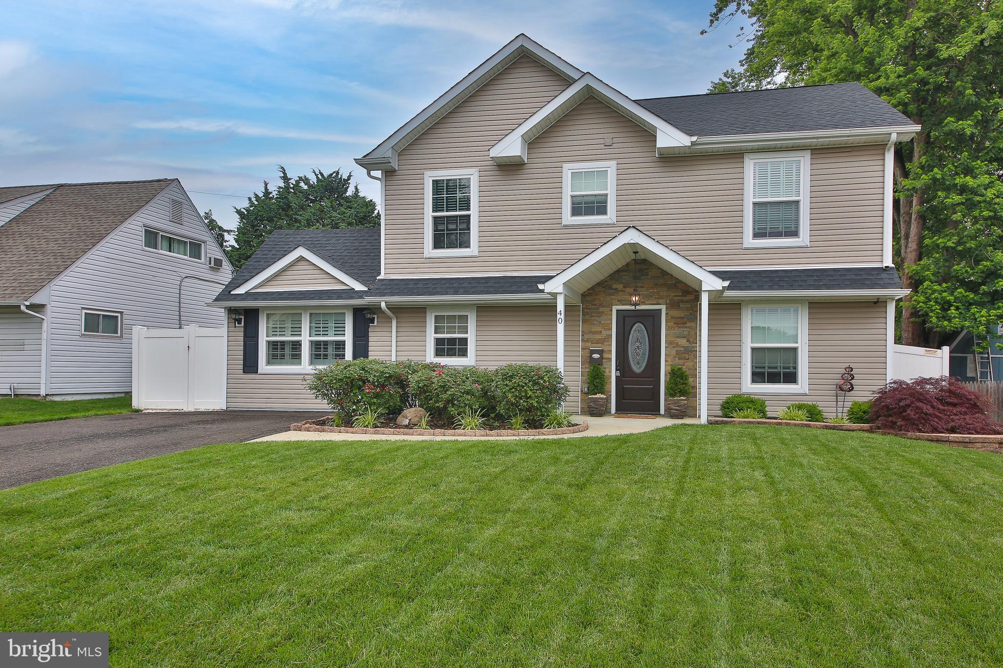 This is home that you have been waiting for.... A one of kind, gorgeous 5 bedroom, 2 full bathroom home, completely rebuilt brand new top to bottom in 2021, including the removal of the original cape cod roof. A full second story was added making this home a true 2 story colonial. Quality finishes and materials throughout are evident as you approach from the street. With a new 4 car driveway, new concrete walkway, stone lined gardens, covered stone front entry, recessed eave lighting, and a manicured front lawn, this property exudes curb appeal. Upon entering, you'll get THAT feeling immediately as you notice the shadow box and chair rail in foyer. The first floor bathroom is beautiful with an abundance of quality tile, glass enclosed tub/shower, and oil rubbed bronze fixtures and hardware. Both first floor bedrooms are a generous size with large closets for your storage needs, recessed lighting and spotless carpeting. The open concept common area features features recessed lighting throughout, recessed ceiling mounted surround sound, engineered plank flooring, and is flooded with light via double french doors leading to the extensive hardscaping in the rear yard. The kitchen is the crown jewel of the ground level for any and all of your culinary needs featuring a center island with seating for two, gorgeous countertops, stainless steel appliances, tile backsplash and dark wood shaker cabinets with brushed nickel hardware. The living room, kitchen and dining room flow effortlessly, perfect for entertaining and comfortable for relaxation. The office (could be used as a 6th bedroom) perfect for working remotely, is just off the dining area and features vaulted ceilings, recessed lighting and a large closet. Head upstairs and you will be floored by the master bedroom with double door entry, double walk in closets, vaulted ceilings and recessed lighting. Head into the bathroom and the luxury continues featuring vaulted ceilings, huge seamless glass and tile shower, tile floor, marble double bowl vanity with oil rubbed bronze fixtures and hardware throughout. Just down the hall is the upstairs laundry closet featuring a stackable Samsung washer and dryer. The second floor is capped off with two additional, generously sized bedrooms featuring recessed lighting and large closets. Head down to the main level and out the double french doors to your, private, backyard paradise featuring PVC panel fencing, extensive hardscaped patio including exterior lighting, and stepping stone walkways, all with stone landscaping making for minimal maintenance. Tons of patio space for you and your favorite people to gather, BBQ and relax. Nothing to do but pack your bags and move right in. Welcome home!