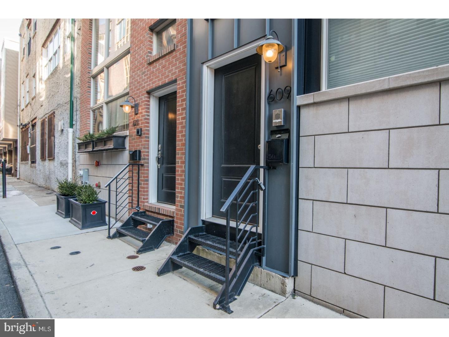 Recently re-listed with a brand new price, this custom built townhome sits on a quiet side street in the heart of Northern Liberties. You enter through an open foyer with beautiful cherry hardwood floors, 20 ft ceilings and a convenient coat closet. There is inside access to an extra wide garage with an abundance of storage space. You will find a cherry wood stairway leading to a contemporary chef's Kitchen with gas cooktop, KitchenAid double wall oven, Thermodor stainless steel appliances and 42" custom cabinetry, custom 10 foot island with Ceaserstone granite and island sink. Breathtaking! This home features four spectacular stories of living space with a finished roof deck for entertaining and incredible Center City views. Additional outdoor space is located just off the kitchen with double sliding glass doors. Relax and unwind in your den or office with large windows, or host a party on your private roof deck with fridge and wet bar: An open floor plan with 3 large bedrooms and extraordinary custom bathrooms. The master suite makes up the third floor with full bathroom containing a double vanity and large walk-in shower as well as laundry. The second bedroom has plenty of closet space and lots of light. The extra wide Garage is fitted with cabinetry/shelving for additional storage and parking for one large car or SUV. This immaculate home has approximately 6 years left of tax abatement. Make an appointment to see this today!