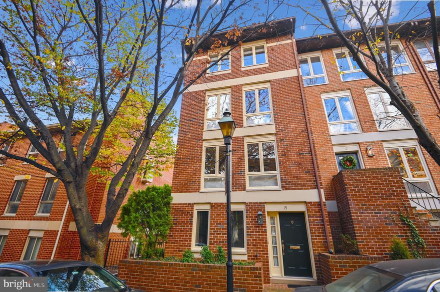 15 W. Lee is an immaculate, light-filled Otterbein end-of-group home with a garage and large parking pad. With well over 2,200 finished square feet, you'll love the neutral decor, sunny exposures, and large room sizes.  The home offers three bedrooms with an additional family room/den/home office on the entry level that could be converted to a 4th bedroom/guest suite.  The main level features beautiful oak floors, an updated kitchen and a lovely wood-burning fireplace in the living room. Sliding doors lead to a large rear deck with replaced Trex decking perfect for outdoor grilling and entertaining.  The home has been seamlessly expanded on the 3rd floor bedroom level to create a large owner's suite with bathroom, laundry and a huge walk-in-closet.  The upper level features two more large bedrooms and another full bath.  15 W. Lee has been meticulously maintained and offers a long list of upgrades.  The home is perfectly located on one of the City's prettiest streets surrounded by mature trees, several neighborhood pocket parks, and extreme convenience to the Inner Harbor Promenade, Federal Hill shops and restaurants and the Camden Yards MARC train and Light Rail.
