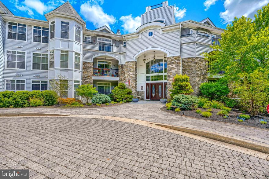 Nestled within the prestigious and desirable Bluffs at Quarry Lake, this exquisite two bedroom, two full and one half bath condominium offers an inspired lifestyle with both luxury and comfort in mind. The spacious floor plan spans over 2200 square feet and is bathed in natural light. Rich hardwood flooring and beautiful moldings as well as recessed lighting enhance the contemporary aesthetic. The gourmet kitchen, adorned with granite countertops , 42" cabinetry, a full stainless steel appliance suite and walk in pantry is a culinary enthusiast's dream.  The Kitchen flows seamlessly into the family room and separate den for effortless entertaining. Retreat to either one of two primary suites, both with lake views and balcony access. The first features a lighted tray ceiling and spacious walk-in closet. The en suite spa-like bathroom has an oversized corner soaking tub and separate shower, providing a serene escape. The second bedroom features ample closet space for guests, a full bath and could easily be utilized as the perfect home office, with a view. Step outside onto your private balcony overlooking Quarry Lake, where tranquil views of the landscaped grounds and serene lake create a picturesque backdrop. Unparalleled community amenities such as a large clubhouse, complete fitness center, outdoor pool, walking / jogging paths and tennis court await. All of this luxury is housed within a secure, gated environment. Convenience is paramount with restaurants and shopping only feet away. There is also an assigned garaged parking space and secure storage locker, all located just outside the elevator. This property not only offers a luxurious lifestyle but also a vibrant community atmosphere, making it the perfect place to call home. Come and experience the best modern luxury has to offer, housed in a setting that truly feels like a retreat.
