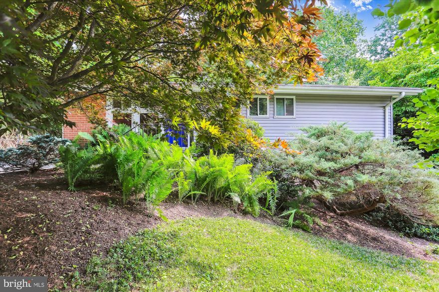 Sophisticated and secluded garden house set back in highly sought after Kemp Mill Estates within Silver Spring. A nature lover’s dream with the conveniences of a suburban home. Zen filled indoor and outdoor spaces. Enjoy the stunning, upscale private backyard oasis, which has a direct path to the popular Northwest Branch Trail. The backyard features a custom designed cedar soaking hot tub, custom flagstone sitting area with massive pergola. New siding and insulation were installed in 2019.

Unique and versatile interior. The main level features vaulted ceilings, recessed lights, and wood flooring throughout. THERE ARE 2 MAIN LEVEL PRIMARY SUITES WITH PRIVATE EN-SUITE FULL BATHS. In 2019 the owners customized the second primary bedroom with a walk-in closet and a full bath with an extra deep tub and uniquely recessed shelves. In addition, there is a 3rd full bath in the hall for the 3rd bedroom and for other guests to use. In 2018 the other 2 main level bathrooms were updated. Enjoy the light and bright updated kitchen with breakfast bar and a pass through to the dining room. Adjacent to the kitchen and dining room is the sun-filled addition which has sliders to the yard, backyard; and overlooks the patio and mother nature. The owners have used the lower level bedroom, which has a private side entrance, as a modern office. The office area features custom wood flooring, recessed lighting, custom sink, and coffee bar. If one wishes, the space can easily be converted into 2 rooms. In the corners of the lower level are a powder room and a guest room. The Floor plans are from Truplace, are provided to show you the layout and the dimensions are deemed to be accurate but not guaranteed. THE HOT WATER HEATER IS NEW AND UPGRADED FROM 30 gallons to 50 gallons; New gutters (2016) Recently installed wooden floor in the sunroom (2017; New Furnace (2016) New roof (2009) New windows (2007) Radon sensor in the basement. New Dryer (-2017). Make your dream a reality and wake up in heaven on earth.