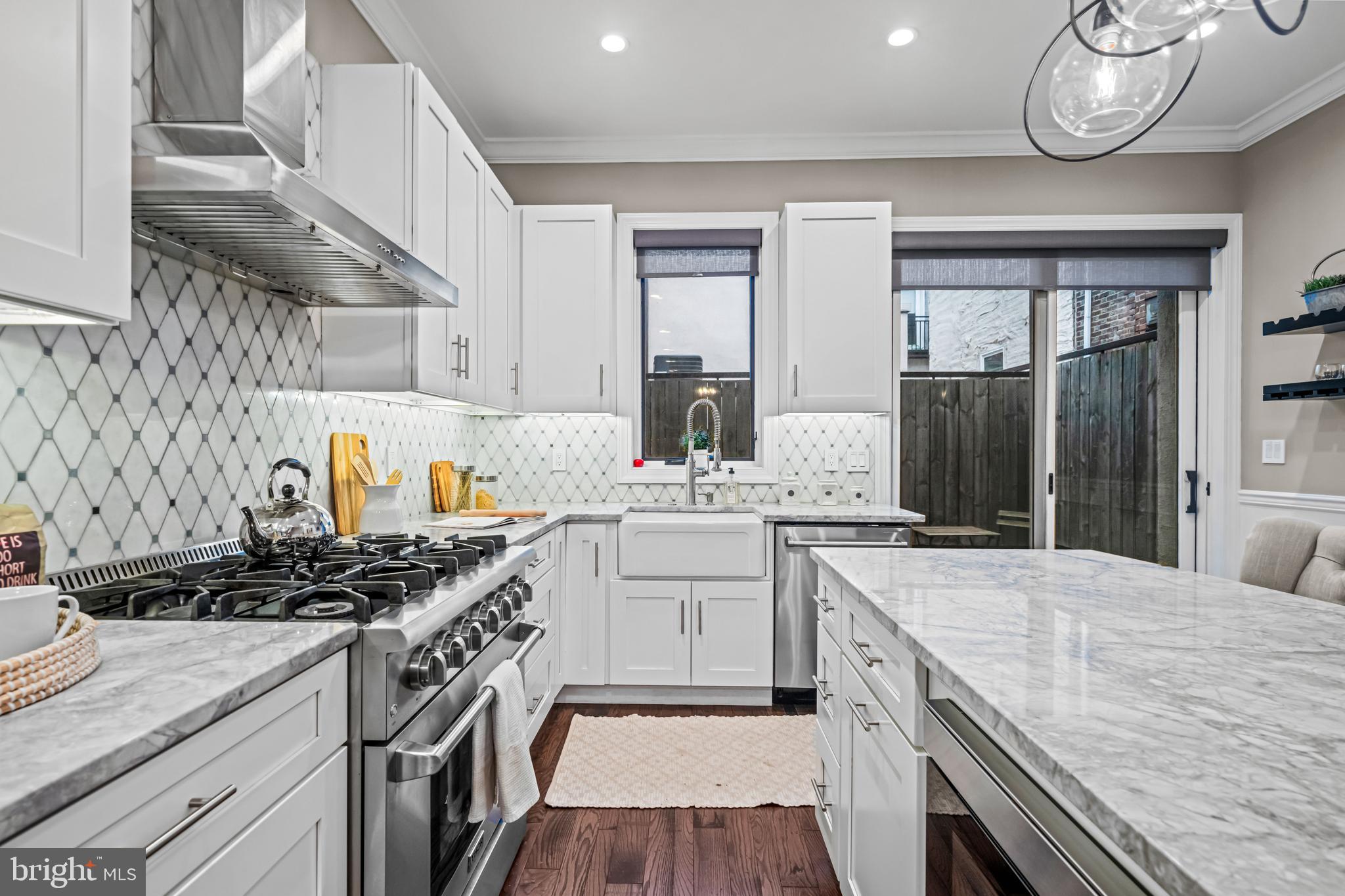 This fully remodeled home will be featured on an upcoming episode of HGTVs “House Hunters”!
Your chance to enjoy Queen Village Living at its finest! This wonderful property which was lovingly remodeled only a few years ago, is appointed with an open floor plan, all the amenities of a modern smart home, while maintaining the charm of a historic Philadelphia residence.
The contemporary Chefs Kitchen is equipped with 42-inch cabinets, marble countertops, large island, under-mount lighting, deep farm sink and custom built-ins & stainless-steel Thor appliances. Living Room / Dining Room are full of natural light, high ceilings, wide solid oak hardwood floors and elegant wainscoting surround. Large sliding doors lead to the private outdoor area with fencing.
Primary Suite has 3 windows, bringing plenty of natural light, and a spa-like bathroom with heated floors. A custom staircase with iron railing brings you to the 2nd floor, with more wainscoting surround and a Hall Bath with heated floors. The front bedroom has 2 closets, and is positioned for plenty of morning sunlight. On the third level you will find a large bedroom with hardwood floors, more natural light and ample closet space. This level has been used as a bedroom, home office, and could also be a supplemental living room or family room area. Third floor doors open to the spacious roof deck with great skyline views.
The finished basement has high ceilings, heated floors, full spa bath, and large closet and storage space including a Laundry and Mechanical Room. This level has the potential as a 4th bedroom, Au Pair suite, or additional entertaining area. In the mechanical closet you’ll find all the necessary wiring and connections for custom, full in-home audio.
Parking at the Queen Village Parking Lot can be found directly across the street.
Queen Village is one of the most sought after neighborhoods in Philadelphia - with many Restaurants, Cafes, Parks, Playgrounds and Dog Parks. Easy Access to Public Transportation, Highways and Bridges. Home located in the district for the Award-Winning National Blue Ribbon William M. Meredith School.