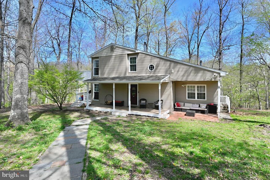 This charming contemporary home, beautifully remodeled and maintained by current owners, offers a perfect blend of comfort and modern living. Nestled on a generous 6.24-acre lot, the property backs to serene woods, providing a peaceful retreat from the hustle and bustle of daily life. The inviting interior features the current owner-installed hardwood floors throughout, complemented by skylights that fill the space with natural light. The owner put in the new HVAC last year, as well as made the huge bedroom on the main level a nice place to be in.  The kitchen is equipped with modern appliances, including a built-in microwave, dishwasher, and electric oven/range, making meal prep a breeze. A convenient main-floor laundry with front-loading washer and dryer adds to the home's functionality. Step outside to discover multiple outdoor spaces, including a spacious deck and balcony, perfect for entertaining or simply enjoying the tranquil views. The property also includes several outbuildings, providing ample storage or workshop space. Located in a welcoming community, this home is close to local parks and recreational areas, ideal for outdoor enthusiasts. Residents benefit from nearby public services and schools, ensuring convenience for all. Experience the warmth and comfort of this delightful home, where every detail has been thoughtfully designed for modern living amidst nature's beauty.