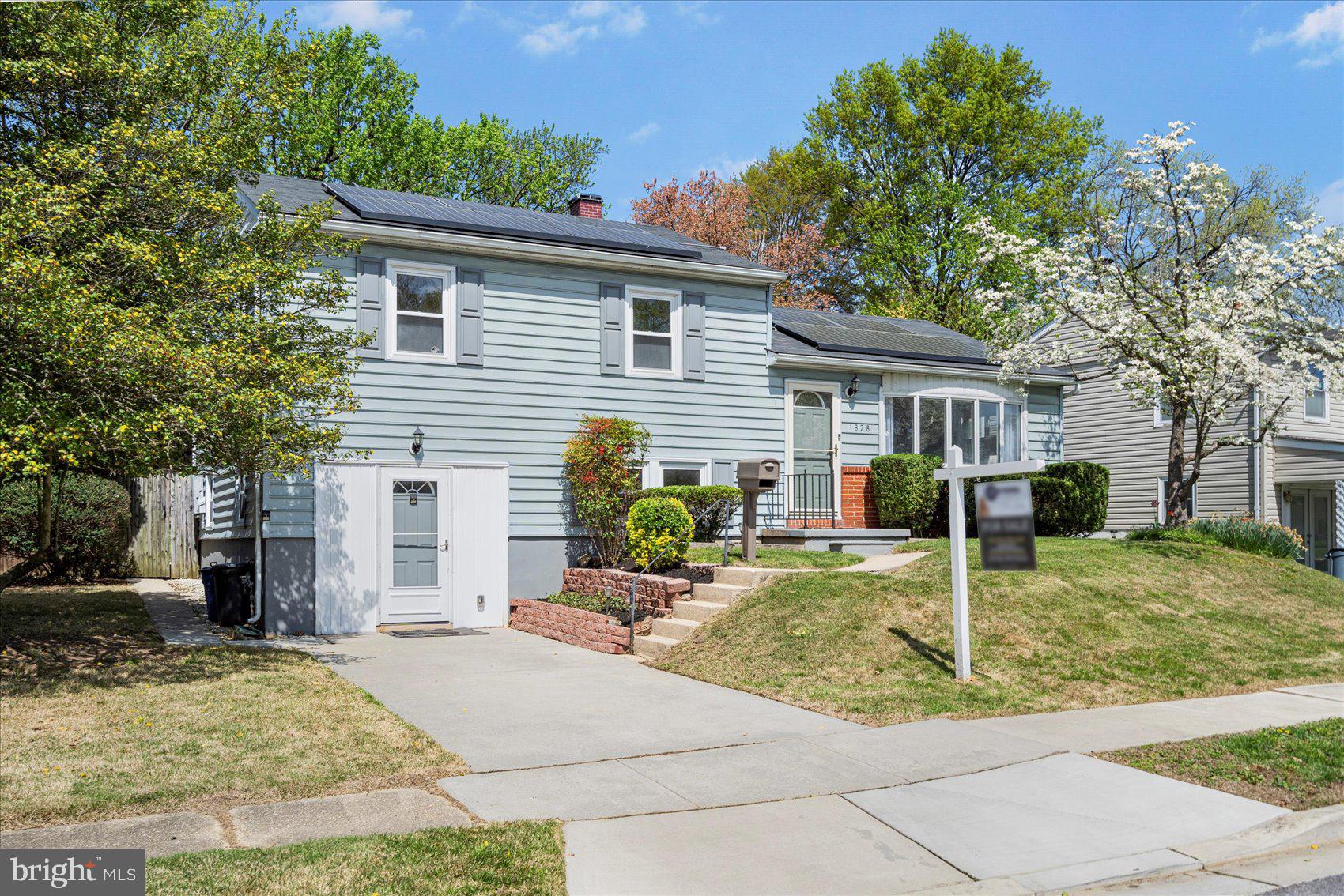 Well maintained and move-in ready 4BR/2.5BA Split level home on a gorgeous landscaped lot in the desirable county side of Parkville. Walk past tiered flower beds on your way to the front door of your new home. Step into the main floor living space featuring a crisp clean interior with tons of natural light, beautiful hardwood floors, and an open floor plan. The spacious living room is open to the dining room which is just steps from the kitchen. The kitchen features plenty of cabinets and counter space, a colorful tiled backsplash, an open shelf, and a stainless sink under a window. The main floor also offers a half bath and a sizable bedroom with access to the half bath. In addition, just beyond the kitchen is a beautiful three season room with large windows, two skylights, and stunning custom tung and groove knotty pine wood panels surrounding the room and the ceiling. Wood flooring continues onto the second featuring two sizable secondary bedrooms, a spacious primary with double closets, and a full bath. The lower level is filled with tons of light and offers additional living space with a large family room featuring a brick wood burning fireplace and wet bar area, a newly remodeled full bath with a jetted soaking tub, laundry, storage, and a walk-out to the driveway in the front or exit to the fenced yard in the back. From the three season room step outside to a beautifully manicured yard with flower beds, a lush green lawn, adult trees, and plenty of room for entertaining family and friends. This home is move-in ready with so much to offer new homeowners and is located in close proximity to shopping, restaurants, and commuter routes.