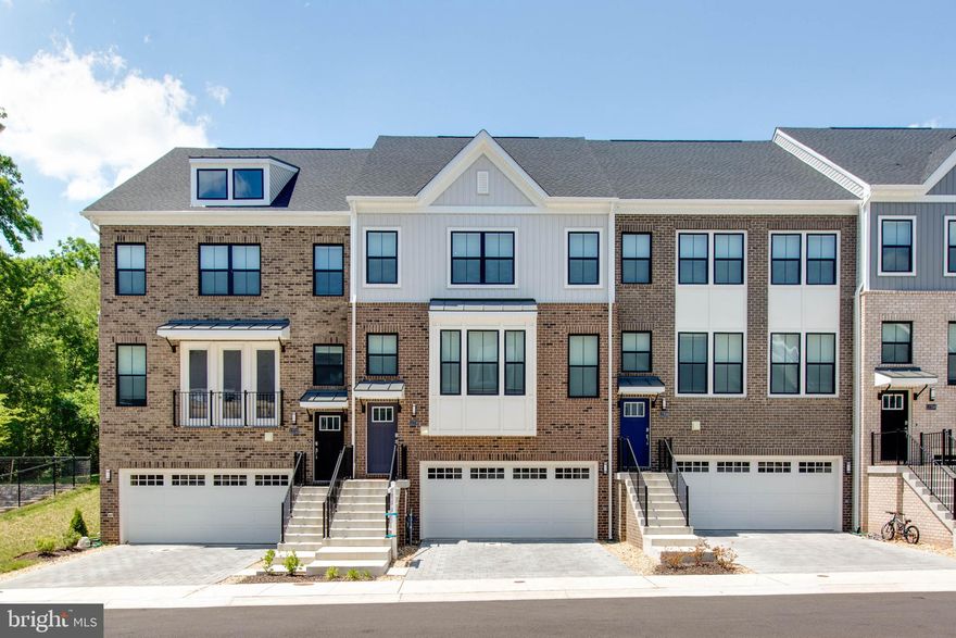 Welcome to this meticulously maintained, contemporary townhome that perfectly blends sophisticated style with everyday functionality. Boasting an open-concept layout and flooded with natural light, this home offers a premium living experience across multiple finished levels. Promise of comfort and style in newest Howard County community. Home features a chef-inspired kitchen equipped with stainless steel appliances, crisp white cabinetry, and expansive quartz countertops. The oversized center island with breakfast bar seating flows seamlessly into the dining and living areas, making it an ideal space for entertaining. High ceilings and recessed lighting enhance the bright, voluminous feel of the main floor. This elegant four-level townhouse offers a perfect blend of luxury and functionality and ready to move in! Enjoy the deck off the family room, offering a perfect spot for grilling, relaxing with loved ones, or enjoying a good cup of coffee.  The upstairs level features intimate spaces, including a laundry area, two secondary bedrooms, and a full tiled bath. The private owner's suite includes a full-sized bathroom with quartz double vanity, a spacious shower with a seat and frameless door, and blinds for added privacy. The fourth-level loft offers additional recreation space, which can be customized for use as a guest area, home office, or family movie-time. The powder room and outdoor rooftop deck with wooded views add to the appeal.  Located near the shops and restaurants at Turf Valley, and with easy access to I-70, Route 29, Baltimore, and Washington, DC, this home provides an ideal location for a modern lifestyle.