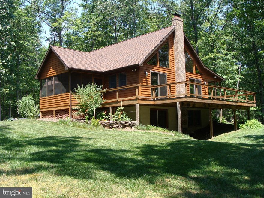Beautiful Cedar Chalet situated perfectly among the ferns on 12.36 wooded acres, enjoy the sunsets and sounds of the stream from your large deck or screen porch,  Natural pine throughout, exposed oak beams, stone hearth with woodstove all enhancing the great room design, 2 master bedrooms, loft setting area, 3 car detached garage. Some finishing work required on this exceptional home.