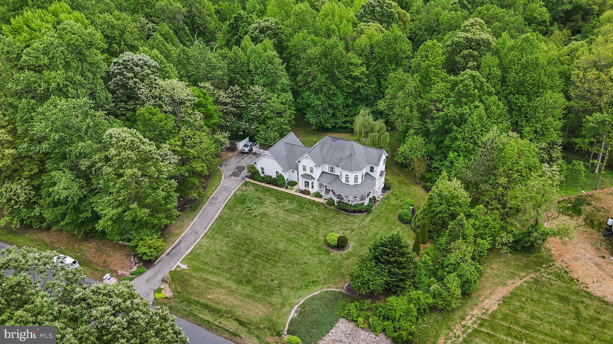 Dream Victorian home boasting over 4300 sq ft, this separates this estate from the rest, with a Tranquil Tree-Lined property Nestled on 3 acres in a peaceful neighborhood surrounded by lush trees and the serene Nanjemoy Creek, this beautiful property invites you to fall in love from the moment you arrive. This community has waterfront access to the Nanjemoy creek which provides private entry to a pier and picnic area, where you can indulge in fishing, kayaking, and crabbing—all just steps from your backyard.
As you approach, you'll appreciate the charming wraparound porch—perfect for relaxing and soaking in the beauty of Mother Nature. Step inside to gleaming hardwood floors and an abundance of natural light pouring in everywhere you look. The spacious floor plan includes a formal living room, a formal dining room, and a bright sunroom—ideal for your favorite plants and morning coffees. Just steps away, enjoy the outdoor paver patio, perfect for entertaining or unwinding amidst nature.
The heart of the home features a family room with a cozy gas fireplace, an eat-in kitchen with stainless steel appliances, granite countertops, and a stylish backsplash. Convenience is key with a dedicated laundry room and half bath, plus thoughtful touches of decorative molding throughout that showcase pride of ownership.
Upstairs, you'll find more moldings and the expansive Owner’s suite complete with a sitting area and a luxurious bathroom featuring a soaking tub, separate shower, and a generous walk-in closet. Three additional secondary bedrooms and a full bathroom provide ample space for family and guests. A hidden door leads to more surprises, featuring over 700 square feet of unfinished attic space that offers tremendous potential for customization. You’ll also find a secret door which leads downstairs to an oversized garage that provides additional storage. Let’s not forget the basement , which boasts a full bath, bedroom/ flex area, rec room and a safe room. Don't miss out on this gorgeous home.