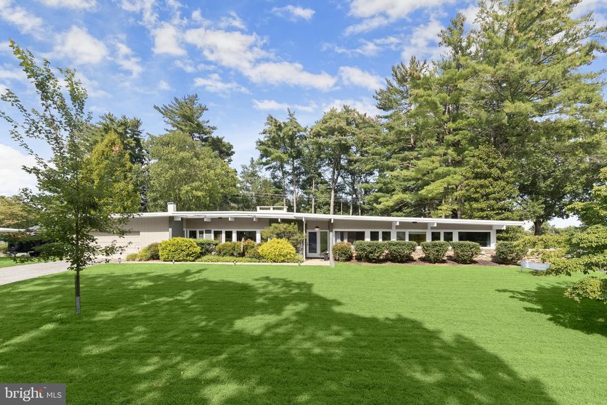 **HIGHEST AND BEST DUE SUNDAY 11/16 by 7PM** Welcome to this stunning Mid-Century Modern home designed and built by Gordon Sugar in the sought-after Stevenson, offering exceptional one-level living with four bedrooms and two-and-a-half bathrooms. Tucked away in a quiet cul-de-sac on a half-acre lot backing to trees, this home’s peaceful setting provides a true retreat. Discover the warmth and charm of this inviting residence filled with natural light, where tall vaulted ceilings, brick walls, and slate and hardwood floors highlight its authentic 1950s craftsmanship. The impressive open-concept living and dining rooms are filled with natural light from floor-to-ceiling windows and sliding glass doors that open to the backyard, anchored by a cozy wood-burning fireplace. A spacious eat-in kitchen includes a breakfast nook perfect for casual meals. Completing this side of the home are a laundry room, half bathroom, and access to the two-car garage. On the opposite wing, the primary bedroom features a walk-in closet and a private ensuite bathroom with a walk-in shower. The second bedroom is a versatile space with sliding built-in cabinets that open to the living room, making it ideal as a den or office. Two additional bedrooms and a shared full hall bathroom with a tub-shower complete the layout. Outside, enjoy the expansive backyard with a large patio and plenty of room for gatherings. An outdoor storage closet holds everyday essentials, while a large underground fallout shelter offers additional flexibility and can be utilized for storage.