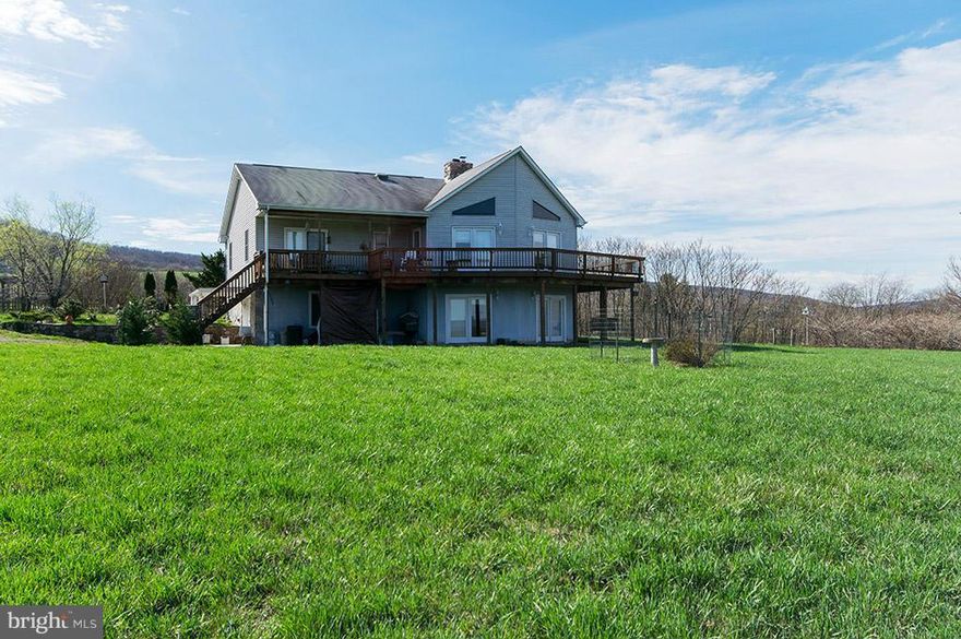 Lg. home on just over 22 acres! Features approx. 12 acres fenced, gorgeous mtn. views! Ready for your horses & livestock. Home has huge main floor Master. Can be changed back to 2 Bedrooms. Floor to Ceiling wood burning FP, new fridge, HVAC/FA Dual comfort zone, newly finished rear deck. Wrap around porch, large finished lower level w/ 2 bedrooms, rec room w/wood stove. WV at it's best!