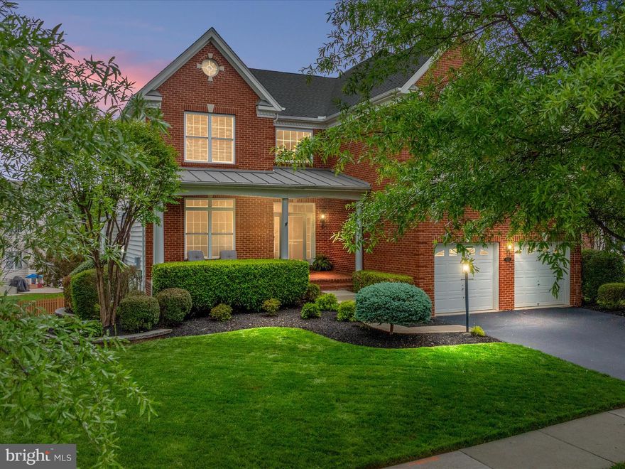 **OPEN HOUSE CANCELED**Discover the perfect blend of elegance, comfort, and convenience in this beautifully maintained Richmond model by Toll Brothers, located in the prestigious gated, golf-course community of Dominion Valley Country Club.  Built in 2011 with timeless brick front curb appeal and a charming brick front porch, this home is nestled on a professionally landscaped lot with a partially fenced yard, Trex deck, stamped concrete patio, and full irrigation system your own private retreat. Step inside to a grand two-story foyer accented with crown molding and updated LVP flooring (2022), setting the tone for this thoughtfully designed home. The heart of the home is the gourmet eat-in kitchen featuring maple cabinetry, granite countertops, a stylish backsplash, stainless steel appliances, recessed lighting, and a spacious island. The light filled solarium addition with vaulted ceiling, plantation shutters, ceiling fan, and a second pantry provides the perfect space for casual dining or morning coffee. Just off the kitchen is the extended two-story family room with a coffered ceiling, gas stone fireplace, and a dramatic wall of windows ideal for cozy nights or entertaining a crowd. Formal living and dining rooms are detailed with shadowbox and crown molding, transom windows, and elegant light fixtures. The main level office with French doors and LVP flooring is perfect for working from home, while the updated powder room and main-level laundry room with Samsung washer/dryer add convenience and style. Upstairs, the luxurious primary suite boasts a vaulted ceiling, sitting area, Palladian window, custom walk-in closet, and a spa-like en suite bathroom with double vanities, soaking tub, and separate shower. Three additional bedrooms, including a bedroom with its own en suite bath, offer generous space and comfort for family or guests. A versatile loft area completes the upper level. The fully finished walk-out lower level includes a spacious recreation area, den could be used as a guest room or home gym with wood  plank tile, recessed lighting, full bath, 9’ ceilings, and a rough-in for a wet bar ready for your personal touch. Built-in shelving in the utility room and garage keeps storage neat and organized. Zone 2 HVAC replaced in 2022. Close proximity to the Waverly Club where you'll find indoor and outdoor pools, a gym, sports courts, and tot lot just a short walk away. As a resident of Dominion Valley, you'll have access to world-class amenities, a renovated clubhouse, Arnold Palmer-designed golf course, multiple pools, tennis and pickleball courts, fitness center, miles of walking trails, stocked ponds, and more. Highly rated on-site schools, proximity to commuter routes, and nearby shopping and dining round out the unmatched lifestyle offered here. Don’t miss your opportunity to own this exceptional home in one of Northern Virginia’s premier resort-style communities. Schedule your private tour today and discover a lifetime of Saturdays!