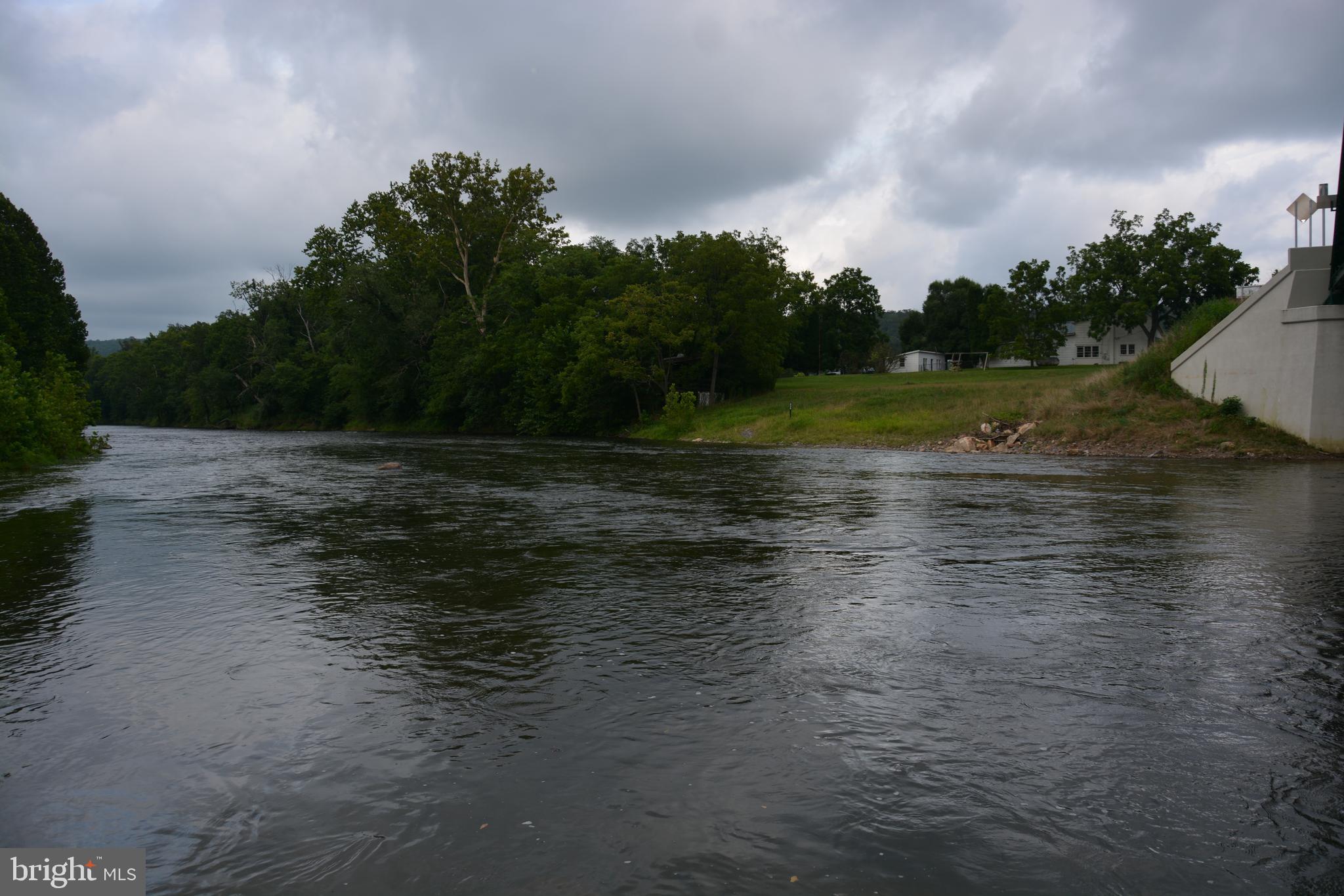 Bring your Kayaks and Fishing Poles! Gorgeous 2-acre dream lot with 280 ft of personal river frontage on the Cacapon River!! Center of lovely town of Capon Bridge. Mostly cleared, partially wooded, with approved access from Whitaker Lane. Top 1/4 acre of the land is approved for residential and is outside of the 100 year flood zone! All utilities, electric, water, sewer... are on the lot and ready to hook up! Walking distance to shops and restaurants. No HOA, ready to build your home, your way. (No restrictions besides those that may be established within the town limits of Capon Bridge.) Great opportunity!