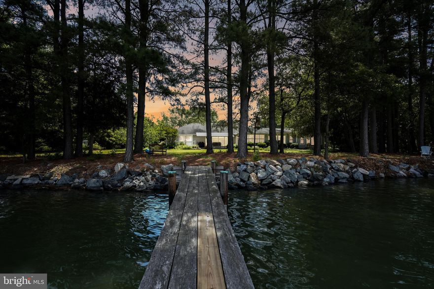 Welcome to the enchanting retreat of Irish ​Cove, where tranquil waterfront living meets ​timeless elegance. Nestled along the ​picturesque Irish Creek, just off the Choptank ​River, this one-level residence invites you to ​experience the epitome of luxury and ​comfort.

Spanning over 4,000 square feet, this ​residence boasts an expansive layout ​designed to capture the essence of waterside living. The moment you step inside, be captivated by the breathtaking water views that ​permeate the living spaces. The home features four generously appointed bedrooms, including two primary ​suites strategically positioned to offer stunning vistas of the surrounding landscape. Warmth and charm embrace you as you gather around the wood-burning fireplace in the heart of the ​home, creating a cozy ambiance that complements the scenic beauty outside. The spacious waterside ​living rooms, adorned with large windows, invite natural light to dance across the interiors, creating an ​atmosphere of serenity.

Step outside onto the expansive waterside deck, a perfect vantage point to savor the beauty of Irish Creek. ​The 2.74-acre lot provides ample space for relaxation and recreation, complete with a private dock for ​seamless access to the water. Imagine spending evenings on your dock, watching the vibrant westerly sunset views over the Choptank River. The property comes complete with an extra-large garage, offering both functionality and ​storage options. Additionally, a large shed and a beautiful fenced garden provide the perfect setting for ​outdoor activities and hobbies. Discover the harmony of luxury, nature, and waterfront living at Irish Cove.