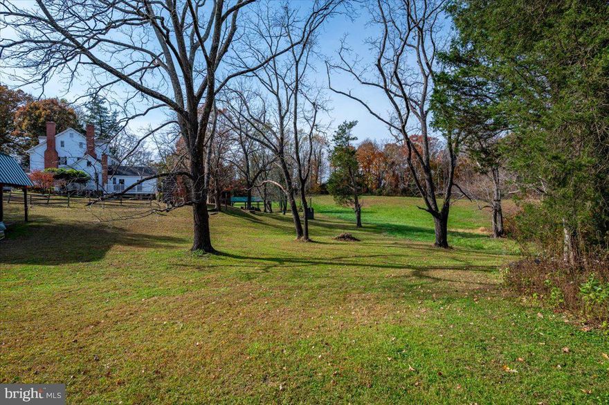 Step into a beautifully restored historic residence in Aquasco, Maryland, where timeless character and modern comfort blend seamlessly across 3,422 square feet of thoughtfully updated living space. Offering six spacious bedrooms and three and a half baths, this remarkable home delivers both presence and practicality.

Set amid gently rolling hills, the property captures sweeping pastoral views and provides abundant open land for horses to roam. The estate is being offered with two mostly cleared parcels totaling 12.65 acres—an increasingly rare opportunity for those seeking privacy, flexibility, and room to expand.

A large, detached barn/workshop and garage enhances the property’s versatility. Whether you’re an equestrian enthusiast, hobby farmer, craftsman, car collector, or simply someone who values substantial workspace, this structure is ready to meet your vision.

Here, you’ll enjoy the tranquility of refined country living while remaining within a convenient drive of Washington, D.C.—close enough for accessibility, yet comfortably removed from the pace of the city, allowing you to enjoy pure serenity. For lovers of historic homes and those envisioning a private estate lifestyle, this offering represents a rare and meaningful opportunity.

Please note: All showings are by appointment only. Kindly do not drive onto the property without a confirmed appointment.