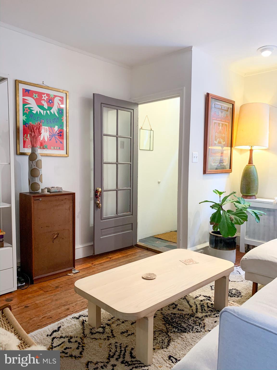 Welcome to a super sunny South Philly splendor!  This beautiful home features original pine wood floors, recessed lighting and a first floor coat closet.  Custom bright white wood cabinets can be found in the kitchen along with Quartz countertops and beautiful blue mosaic tile backsplash.  The backyard is a true oasis with a 6 year old American horn beam tree, rain water barrel and plenty of room to entertain or relax with a book! Upstairs you'll find 3 skylights that fill the home with beautiful bright light!  There are two large bedrooms and a large walk in closet/dressing room.  The front bedroom features exposed beams and lofted area.   The bathroom has been meticulously re-done with stunning blue encaustic cement tile on the floor, modern subway tile in the shower and on the walls and beautiful modern hardware and light fixtures.  The basement is clean and dry with washer/dryer as well as plenty of storage space!  This is a true gem of South Philly - so close to the shops and restaurants of Passyunk Ave!