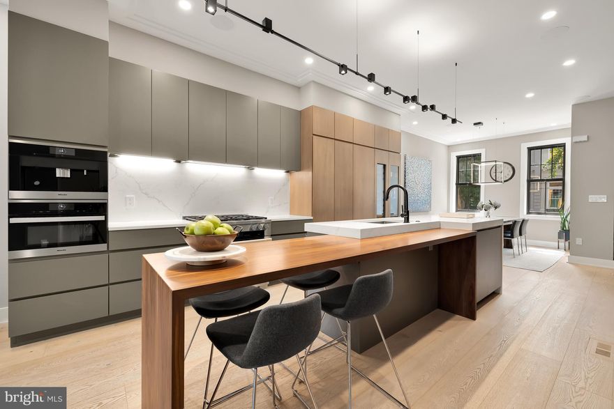 Nestled on one of DC’s most coveted Ginkgo tree-lined one-way streets, 1519 Swann St NW is a masterfully renovated 4-bedroom, 4.5-bathroom residence that harmoniously blends sophisticated living and timeless elegance.  The current owner rebuilt this custom home through a lens of thoughtful architectural design, bespoke craftsmanship, and top-tier finishes.

Step inside and be captivated by the 10-inch wide white oak flooring that guides you through the expansive spaces, where rich textures of brick, steel, and stone create a striking aesthetic. The main level is a seamless flow of refined living, dining, and kitchen areas that open to a private outdoor patio complete with Ipe decking, custom planter boxes, and secure two-car parking. The gourmet kitchen is a stunning centerpiece, featuring a custom bi-level quartz island with eat-in seating, and Miele and Thermador appliance including a built-in coffee machine and wine refrigerator, all elegantly concealed behind Cristiana custom walnut cabinetry. This entire level is an entertainer’s dream offering effortless indoor-outdoor living.

The residence's most awe-inspiring feature is the custom floating staircase with 4-inch solid white oak treads, gracefully connecting all levels. Ascend to the second floor, where two beautifully appointed bedrooms and two luxurious bathrooms await, complete with Hansgrohe fixtures and Porcelanosa tile, a spacious Den, and laundry. 

The top level is entirely dedicated to a luxurious primary ensuite, featuring a lavish walk-in closet system and a spa-like bathroom with a freestanding jetted tub and a massive frameless spa-shower. The generously sized bedroom opens onto a private deck offering tranquil views of the Masonic Temple.

The lower level is an entertainer’s dream offering a fourth bedroom, full bath, and a spacious recreation room with a sleek kitchenette that includes a built-in refrigerator, speed oven, and ample storage.  Movie nights are elevated with the state-of-the-art home theater, equipped with Dolby Atmos surround sound and in-wall speakers for a truly immersive experience.

This exceptional property includes solid wood 8-foot doors on the above-ground floors adding both privacy and architectural allure, while Sonos speakers on the main and top floor sets the perfect ambiance. 1519 Swann St NW offers a rare opportunity to own a one-of-a-kind Logan Circle residence, where sophistication, modern luxury, and comfort converge on one of the neighborhood’s most beautiful streets.