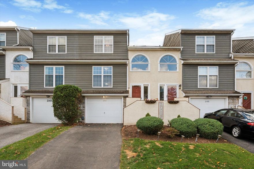 Welcome to this spacious townhome in the sought-after Ballinahinch neighborhood. Offering a bright, open floor plan & warm, inviting spaces, this home blends comfort, convenience, & style in every room. Enter through the welcoming foyer with hardwood floors & a dedicated area to hang your belongings. Walk up to the main level & enjoy stunning HW floors throughout & an airy layout designed for effortless everyday living & entertaining. The eat-in kitchen boasts classic wooden cabinetry, solid surface counters, tile backsplash, & an oversized window allowing natural light to pour in. Thoughtful architectural openings between the kitchen & dining room create a connected feel while still defining each space. The dining room overlooks the inviting family room, complete with a gas fireplace, bonus TV with mount, & sliding doors that lead to the rear deck — perfect for morning coffee or evening relaxation. A convenient powder room & a large coat closet are also located on this level, adding practical everyday function without interrupting the open flow. Upstairs, you’ll find two generously sized bedrooms with abundant closet space. Walk into the primary bedroom through the double door entry & find carpeted flooring, overhead light/ceiling fan, ample windows, walk-in closet & an en-suite full bath. The primary bath features glass door shower, functional vanity with solid surface counters, tile flooring & accent shelving. The second bedroom also features carpeted floors, overhead light/ceiling fan & bonus TV with mount. The second full bath features a classic design with tub/shower, tile floors & single sink vanity. Finally, a hallway linen closet & the upper-level laundry with bonus shelving adds extra daily convenience. The finished lower level offers incredible versatility with carpeted floors, recessed lighting & direct access to the one-car garage. Use this flexible space as a family room, home office, guest room, or playroom — whatever fits your lifestyle. Additional highlights include HOA amenities such as tennis courts & playground plus a 1-year home warranty for the Buyer!! Enjoy a prime location within walking distance to Barnaby’s, just a few minutes drive to Media Borough & easy access to major highways, SEPTA, shopping, dining, & entertainment. This wonderful home is move-in ready & waiting for its next chapter. Don’t miss your opportunity to make it yours.