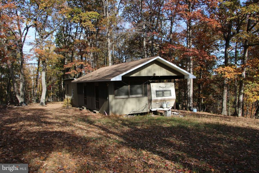 Own a piece of the beautiful Siler Heights community in Cross Junction. Located just minutes northwest of Winchester near Lake Holiday. Access is secured via extensive road frontage on Easter Ridge Lane. Features a fully functional hunting cabin wired for a generator hook up with propane used for heating and cooking. The cabin has an open layout and separate sleeping quarters in an attached camper. Experience exciting hunting as many types of wildlife call this property home including deer, turkey, and many small game species. There are potential building sites located throughout the property. This tract is currently being used for recreation but it would also make an excellent site for your dream home or vacation rental. An expired 3 bedroom septic permit is on record with the county health department. Stellar views of the surrounding countryside are attainable with some tree clearing. This property features mildly sloping topography which is builder friendly and allows for enjoyment of the land. Currently enrolled in the county’s forestry land use program to reduce the annual taxes. This is a fully wooded property that is zoned Rural Areas (RA). Enjoy hiking, camping, and recreation of all types on this land. A short drive from all the amenities and attractions Winchester has to offer. 

***Additional adjoining acreage available for purchase. See aerials for details.***
***The land and cabin are being sold in AS-IS condition.***