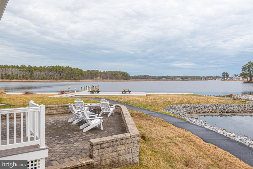 Stunning Waterfront Views: Perfectly positioned at the end of a quiet cul-de-sac in the sought-after location within Swann Cove community, this coastal home offers breathtaking views of the bay and pond. Designed for both comfort and coastal vibe, the residence features five bedrooms and five full baths, along with a versatile flex room currently used as a sixth bedroom—ideal for accommodating family and guests. The main level offers a thoughtfully designed layout highlighted by a spacious great room with expansive water views, a well-appointed kitchen with center island, and a first-floor primary suite. Also on this level are an additional bedroom with full bath, a den, a private office, another full bath, and a convenient laundry room located just off the oversized two-car garage. Outdoor living is a standout feature of the home. Just off the great room, a three-season porch and open deck overlook the beautifully landscaped paver patio, where the panoramic views of the Dirickson Creek and Swan Cove pond create an unforgettable backdrop for relaxing or entertaining. The second level offers additional living space with a loft currently used as a cozy TV and reading nook, a separate rec/game room, and three additional bedrooms with two full baths, providing plenty of room for family and guests. Located just a short walk from the community kayak launch, dock, and bay access. Swan Cove also offers an array of amenities including an in-ground pool, fitness center, community pier and dock, playground, and walking paths. The community does allow weekly rentals, making it an excellent opportunity as a primary residence, coastal retreat, or investment property. Ideally located just three miles from the beaches of Fenwick Island and Ocean City, with convenient access to shopping, dining, golf, and the popular Freeman Arts Pavilion.
Offered partially furnished, this remarkable home is ready to be enjoyed. Private showings only.