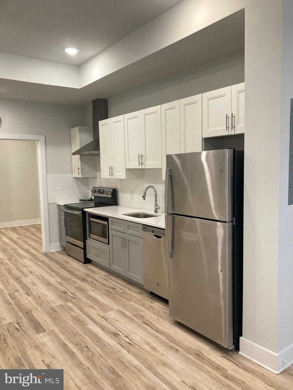WELCOME HOME...This spacious and light drenched 2 bedroom/2 bathroom unit is well appointed with a sleek and modern kitchen, wood floors throughout with in-unit washer/dryer and intercom system. The kitchen has stainless steel appliances inclusive of electric stove, built in microwave with vent, fridge, and dishwasher. The living area is open and airy; just awaiting your decor to make it your home. The primary bedroom has large windows, spacious walk thru closet and private full bathroom with glass shower. Fitness center in building for added convenience as well as an outdoor common area perfect for grilling and enjoying the summer days. About The Neighborhood: Located just one block from the York-Dauphin MFL Septa station, you'll have quick access to Fishtown, Temple Area, Center City in just minutes! The Septa 3 and 39 buses are conveniently on the same block, and local favorites like Martha, Atlantis the Lost Bar and Franny Lou's Porch are all within walking distance. Pets are conditional on owner's approval and may require an additional fee, if accepted. (Generally $500/dog and $250/cat, or monthly pet rent). Tenants responsible for all utilities: $65 flat water fee, gas, electricity, cable/internet.