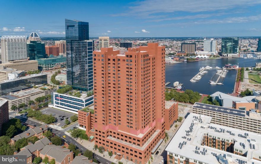 Welcome to The Towers at Harbor Court- a luxury hi-rise condominium located in Baltimore's vibrant Downtown/Inner Harbor area.  This rarely available  3-bedroom + den, 2.5-bathroom model offers over 2,100 square feet of living space, with expansive rooms and spectacular views. Includes new white oak flooring.  The heart of the home is the recently remodeled gourmet kitchen, a chef's delight with quartz countertops,  under-cabinet lighting and top-of-the-line appliances including a Wolf induction stove, Cove dishwasher, and GE Café refrigerator, plus thoughtfully designed extra storage space (with room for a freezer), ample pantry and convenient newer LG washer and dryer.  New electric hot water heater.
The spacious primary bedroom suite features multiple built-ins and a stunning bath with separate tub, oversized shower, dual granite topped vanity and magnificent city views. One bedroom has extensive built-ins for use as an office. Extensive storage and closets throughout other rooms.   An airy and light filled living and dining combination area features ambient modern lighting, new chandelier and floor-to-ceiling windows with views of the harbor, the promenade and Aquarium.  
 Harbor Court offers exceptional service and a wealth of amenities. With 24/7 front desk coverage, a uniformed doorman, porters, security, maintenance staff, secure deeded parking (one space), and additional personal storage, every need is thoughtfully addressed. The prime Inner Harbor location also gives residents access to the adjacent Royal Sonesta Hotel, including optional membership at the fitness center and pool/spa.  For those seeking effortless living in a luxurious, amenity-filled environment, The Towers at Harbor Court is a must-see! Positioned near the Inner Harbor, this residence offers proximity to cultural landmarks, diverse dining, and sports and entertainment venues.