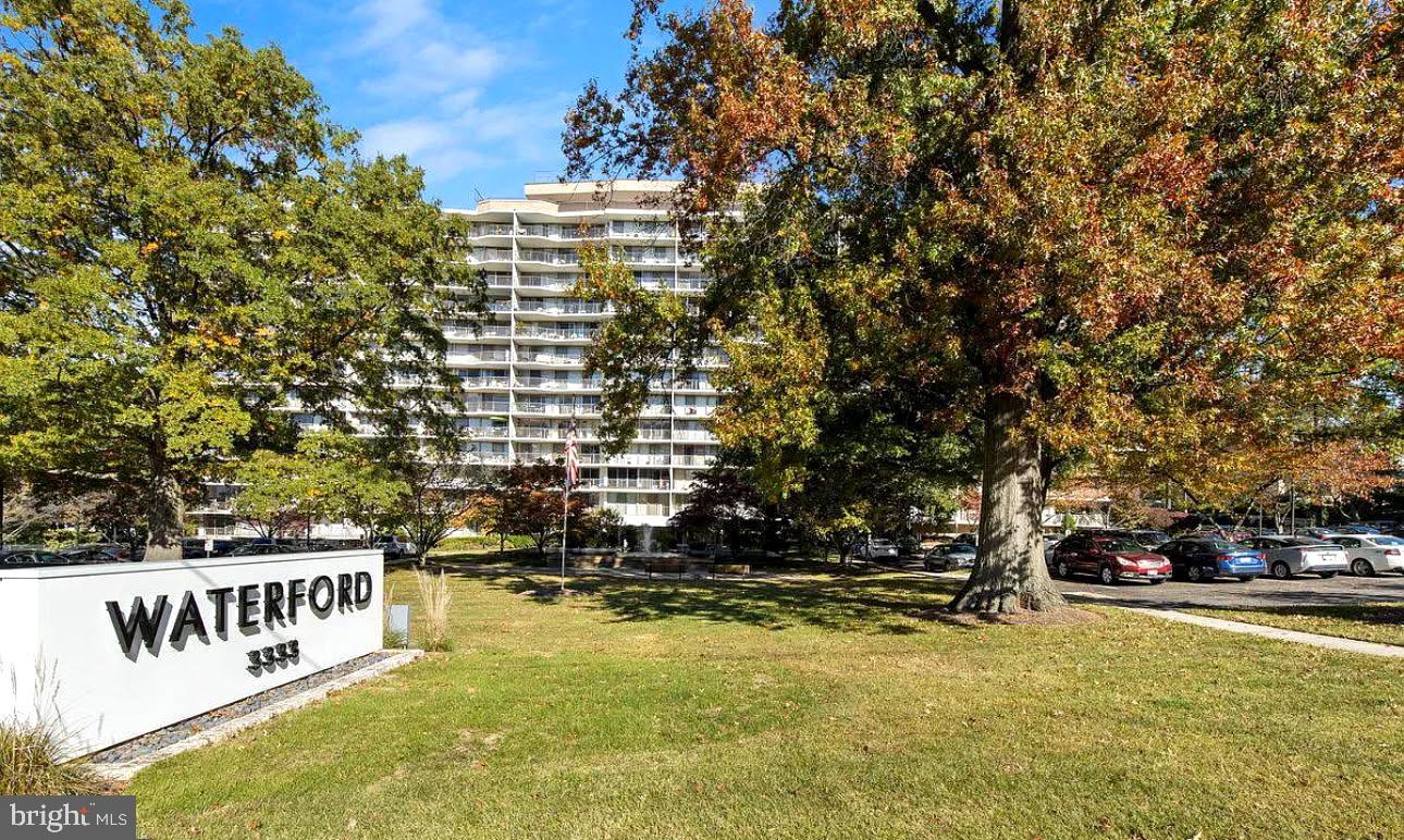 Welcome to The Waterford—Kensington’s sought-after high-rise! This lovely 7th-floor 2-bedroom, 2-bath condo sits just above the treetops, offering peaceful fountain views through floor-to-ceiling windows in every room. A full-length balcony, accessible from the living area and both bedrooms, creates a private retreat—perfect for morning coffee, relaxing evenings, or an urban garden. Inside, the open living and dining area flows effortlessly, ideal for everyday living or entertaining. The galley kitchen is equipped with a newer dishwasher, gas stove, and updated light fixture. The spacious primary suite features a walk-in closet and en-suite bath, while the second bedroom has its own adjacent full bath. The unit is located near the elevator and includes a main-level storage space (#127). The monthly condo fee covers all utilities except cable and internet and provides access to an array of amenities, including a secure building entrance with concierge service, Amazon lockers, a rooftop pool and party room, outdoor patio, and ample unassigned surface parking (one pass per registered occupant plus two guest passes). Potentially wood parquet floor under carpet. Recent updates to the stylish lobby and basement laundry room add even more appeal. For heating/cooling the building controls the seasonal switchover or changeover and repairs, for the most part, can be handled by staff but replacement is responsibility of owner. The Waterford is both pet-friendly and commuter-friendly. Bus routes #4, #34, and M22 stop outside the main street, while Wheaton Metro, Westfield Mall (featuring Costco, Target, Starbucks), and a variety of restaurants and shops are about a mile away. NIH, Walter Reed, and Downtown Silver Spring are within a 3–4 mile radius, and there is easy access to Connecticut Avenue, Georgia Avenue, and I-495. Directly across the street, Kensington Heights Park offers even more green space to enjoy.