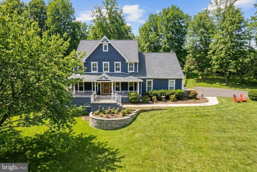 Welcome home to Teckel Hill! Charming Craftsman Style Home Fully Renovated!  5755 Hunton Wood Dr. in beautiful Broad Run, VA.  The home is situated on a gently rolling 1.3 acre lot perfectly sited on top of a lovely hill.  Recent upgrades include new hardy plank siding and vinyl trim, new windows, new craftsman style doors, new garage door with new opener, renovated porch with new roof, recessed lights, and vinyl railings.  The exterior is very low maintenance and the expansive outdoor living areas are great for entertaining guests.  Additional exterior upgrades include new stone walls, stone chimney, stone flower beds, and hard scaping.  The house has stone paver sidewalks to the front door and around the house from the walkout slider door.  There is a newly added patio with the sidewalk to the large rear patio.  New privacy and split rail fence keeps it safe for pets and children.  And who doesn't love a large wraparound covered porch to enjoy! 
As you enter the main level through the gorgeous craftsman door you're greeted with hardwood floors throughout that have been refinished.  The main level has a study, powder room, formal living room, dining room, family room, and kitchen.  The kitchen is open concept to the family room and mudroom area that exits into the garage.  The family room has a cozy fireplace, renovated with tile hearth, as well as built-in bookcases and TV armoire.  The gourmet kitchen has black shaker hardwood cabinetry, quartz countertops, a gas cooktop, wall oven, and a convection microwave oven.  Gorgeous black stainless appliances and a large picture window that looks into the rear yard.  The kitchen has a large island and peninsula sitting area with plenty of storage.  This expansive floor plan is excellent for entertaining and everyday living.  The formal living room has craftsman farmhouse trim on the walls.  The upper level has four bedrooms, including the primary suite.  The primary suite consists of two large rooms, a large, walk-in closet, a secondary closet, and an en-suite bath with travertine stone tile.  The bathroom is equipped with a large, enclosed glass shower and soaking tub with dual sink vanities.  Upstairs, you will find a large laundry room and large hall bath all renovated with new tile, built-ins, and dual sink vanities.  The upper level has no carpet, all the bedrooms have wood plank flooring, overhead lighting, and generous closet space.  The primary suite has a walk upstairs to an unfinished attic area for storage.  In the lower level, you will find room for a guest with a third renovated full bathroom, two bonus rooms, one being used as a large walk-in closet and an L-shaped open rec room that exits out to the patio.  The entire interior and exterior have all been renovated within the last few years.  The current owners have added plantation shutters and blinds to all bedrooms and main level windows.  The house is stunning with decorator tile and paint accents throughout.  Not a stitch of carpet to be found in this spacious, gorgeous three level home!  There is nothing left to do but move in and enjoy!  The house is located in a small neighborhood in Broad Run near the edge of Haymarket.  Shopping restaurants and stores in Haymarket are 10 to 15 minutes from the property.  Don't miss this extraordinary opportunity, schedule your showing today.